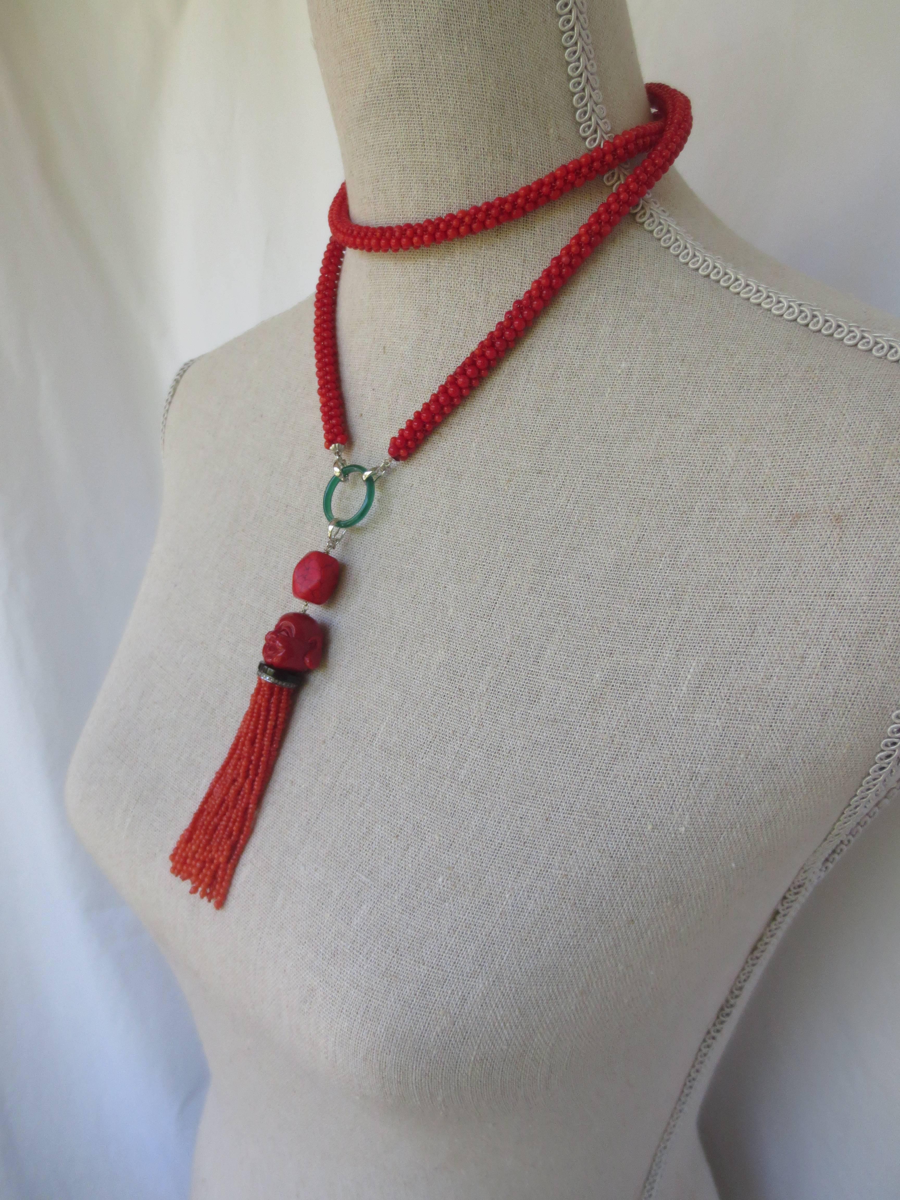 Coral beads are tightly woven using rope style techniques, to create a dimensional and robust piece. This multi-functional necklace can worn long and open, or wrapped and snug; with or without tassel. 14 k white gold findings suspend a green onyx