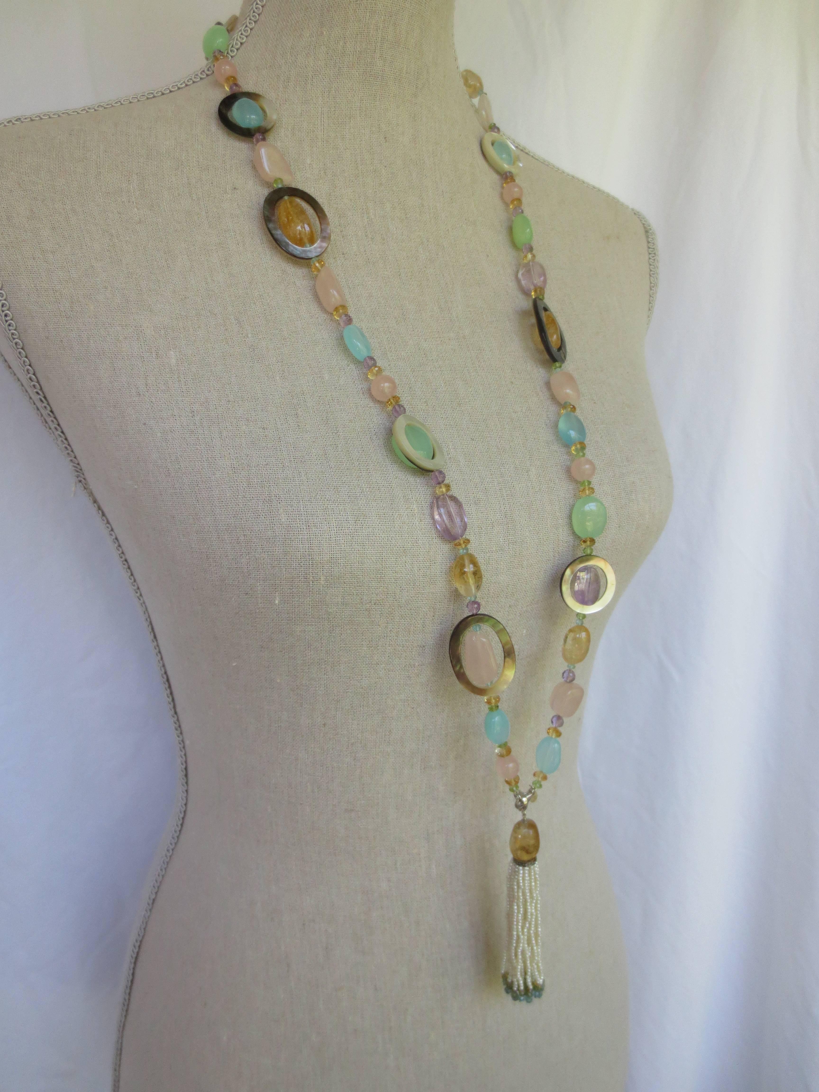 Multi color semi-precious stones Citrine, Pink quartz, Blue and Green Apatite, Amethyst, Peridot, Florite, London Blue Topaz, and Mother-of-Pearl are combined to create a gorgeous shimmering piece. 

Without tassel, necklace measures 38 inches