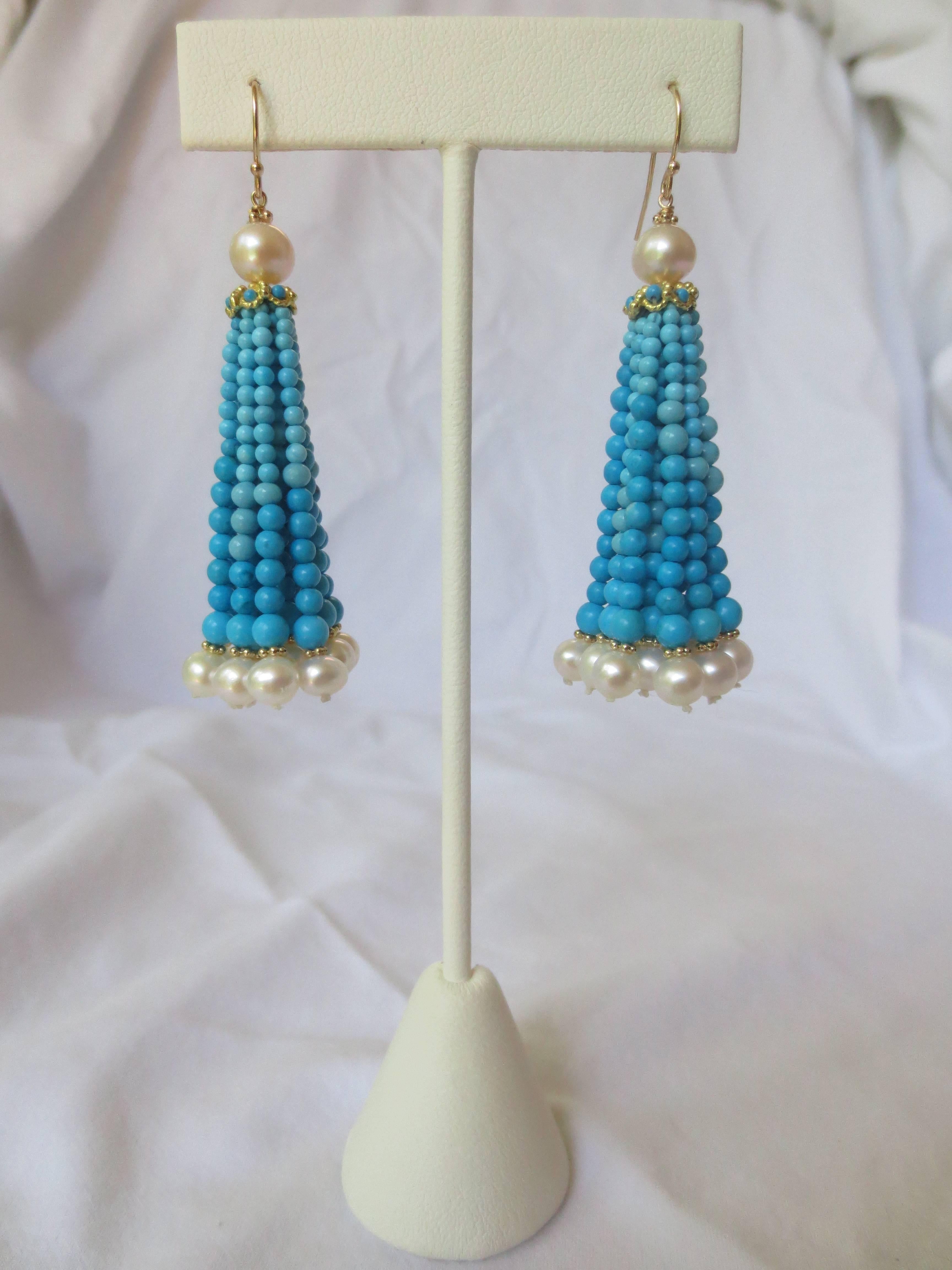 Graduated in size and color gradient, these dangle earrings are sure to brighten any ensemble. Secured with 14 K Gold findings, the 6 mm top pearl is attached to a gold filigree cup, decorated with small beads. The turquoise tassels range from 1