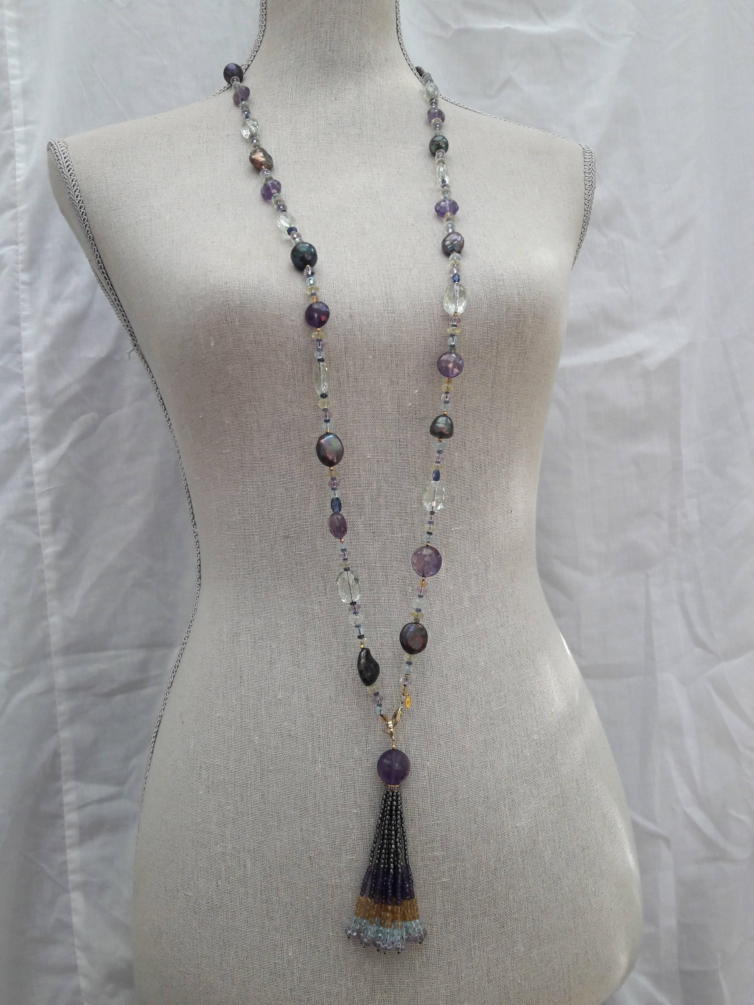 Multi color semi-precious stones citrine, amethyst, florite, sapphire, aquamarine and black pearl are combined with fine gold beads to create a gorgeous shimmering piece. 

The tassel is composed of amethyst, citrine, and aquamarine faceted beads,