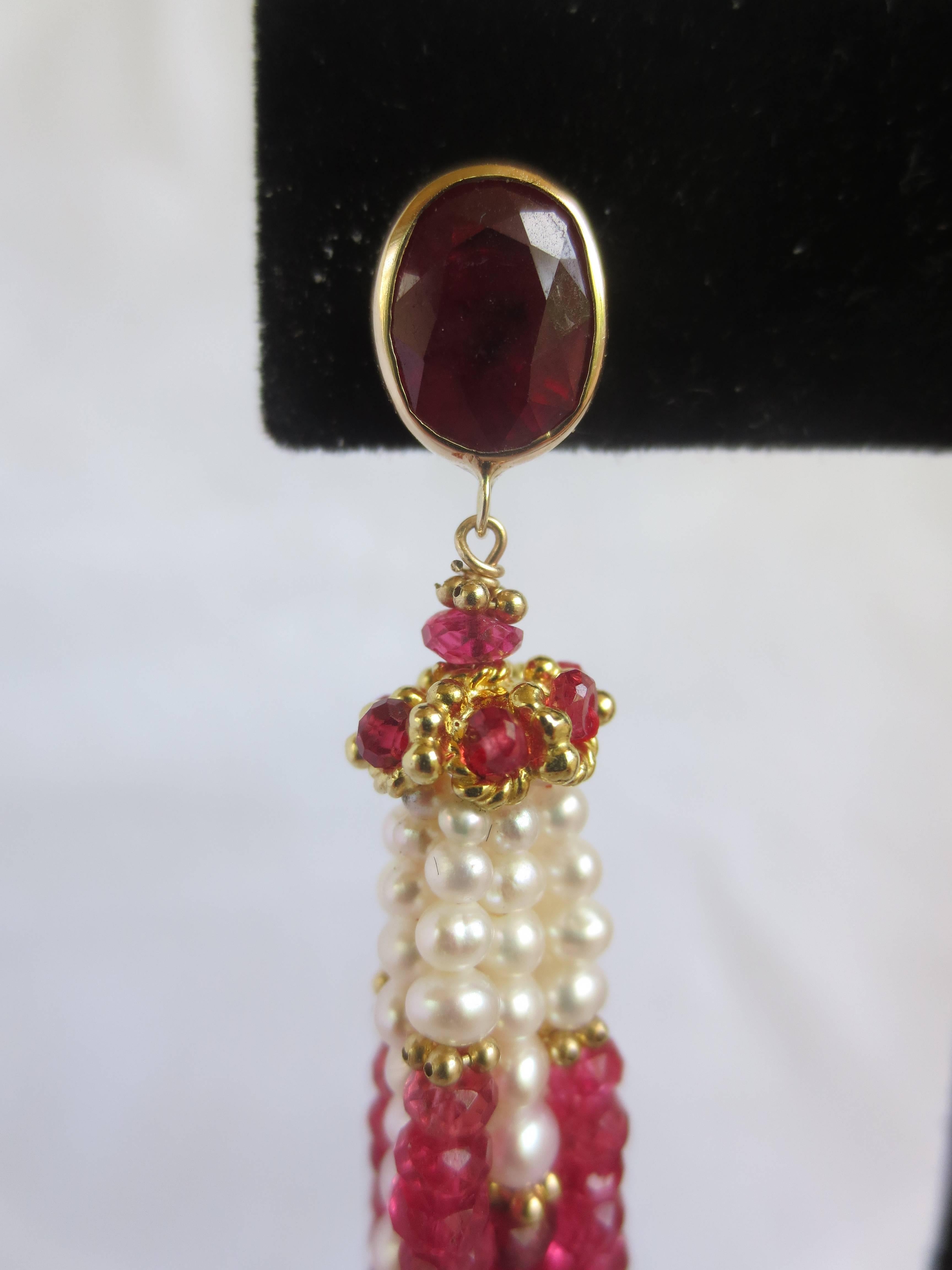 This colorful and unique pair of earrings are an exclusive design from Marina J.

Starting with a large (6 mm X 9 mm) and luscious faceted Ruby stone framed in 14 K Yellow Gold, these earrings will sit close and snug by using a Gold post instead