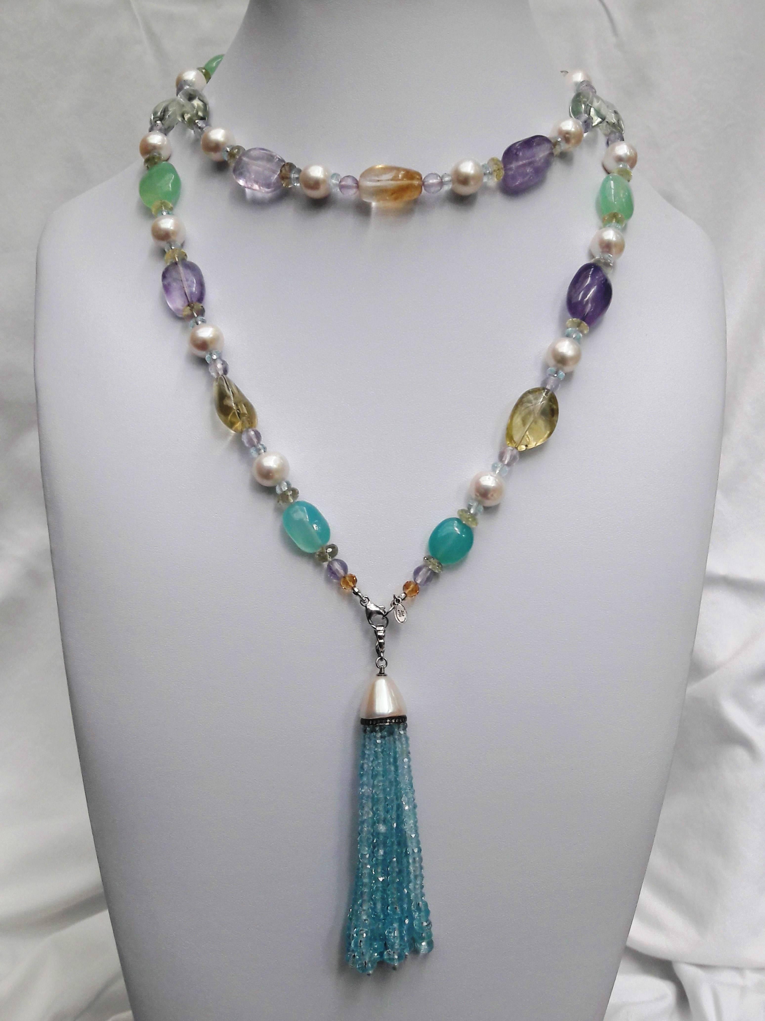 Large round pearls are paired with Amethyst, Citrine, Aquamarine, Green Garnet and Fluorite beads to create a gorgeous shimmering piece. The semiprecious stones highlight the luster and iridescence of the pearls, and are divided with small faceted