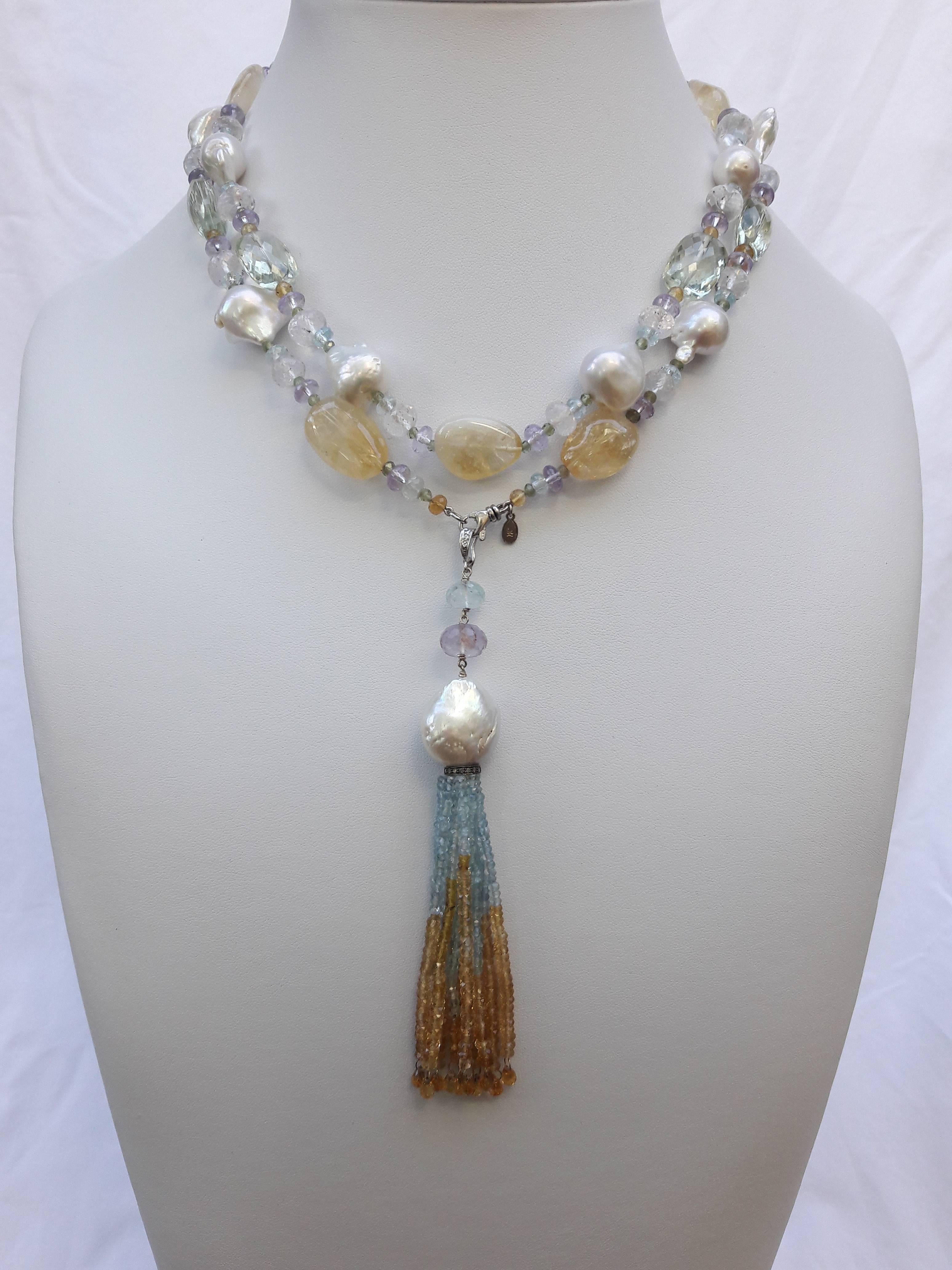 Baroque pearls are paired with Amethyst, Citrine, Aquamarine, Green Garnet, Fluorite, and Rose Quartz faceted beads (of various shapes and sizes) to create a gorgeous and shimmering piece. The semiprecious stones highlight the luster and iridescence