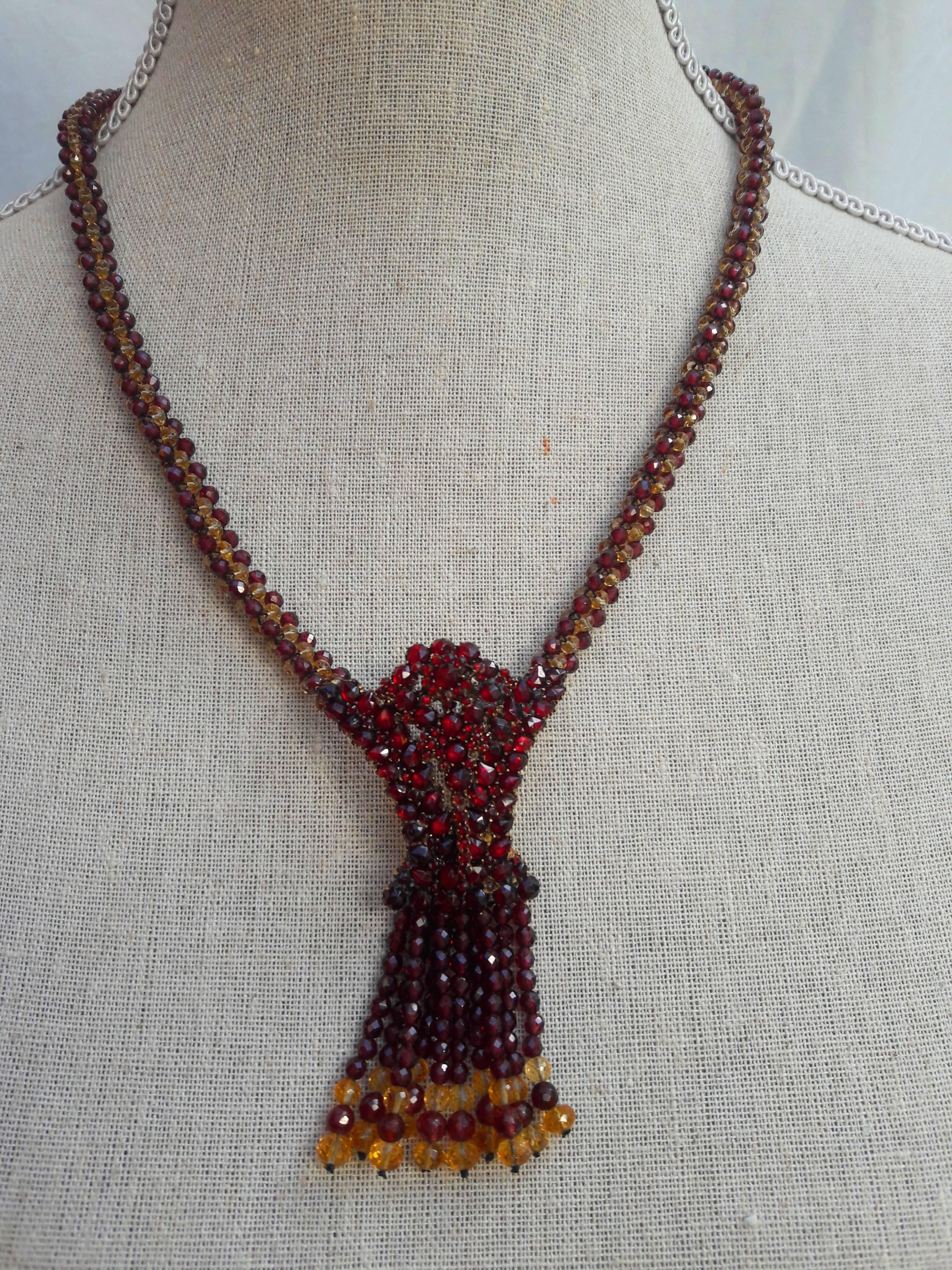 A truly one of a kind piece. This sophisticated and dramatic necklace makes a very visual statement.

Faceted Citrine and Garnet faceted beads (3mm) are woven together into a tight, round rope. This unique design makes for a very comfortable wearing