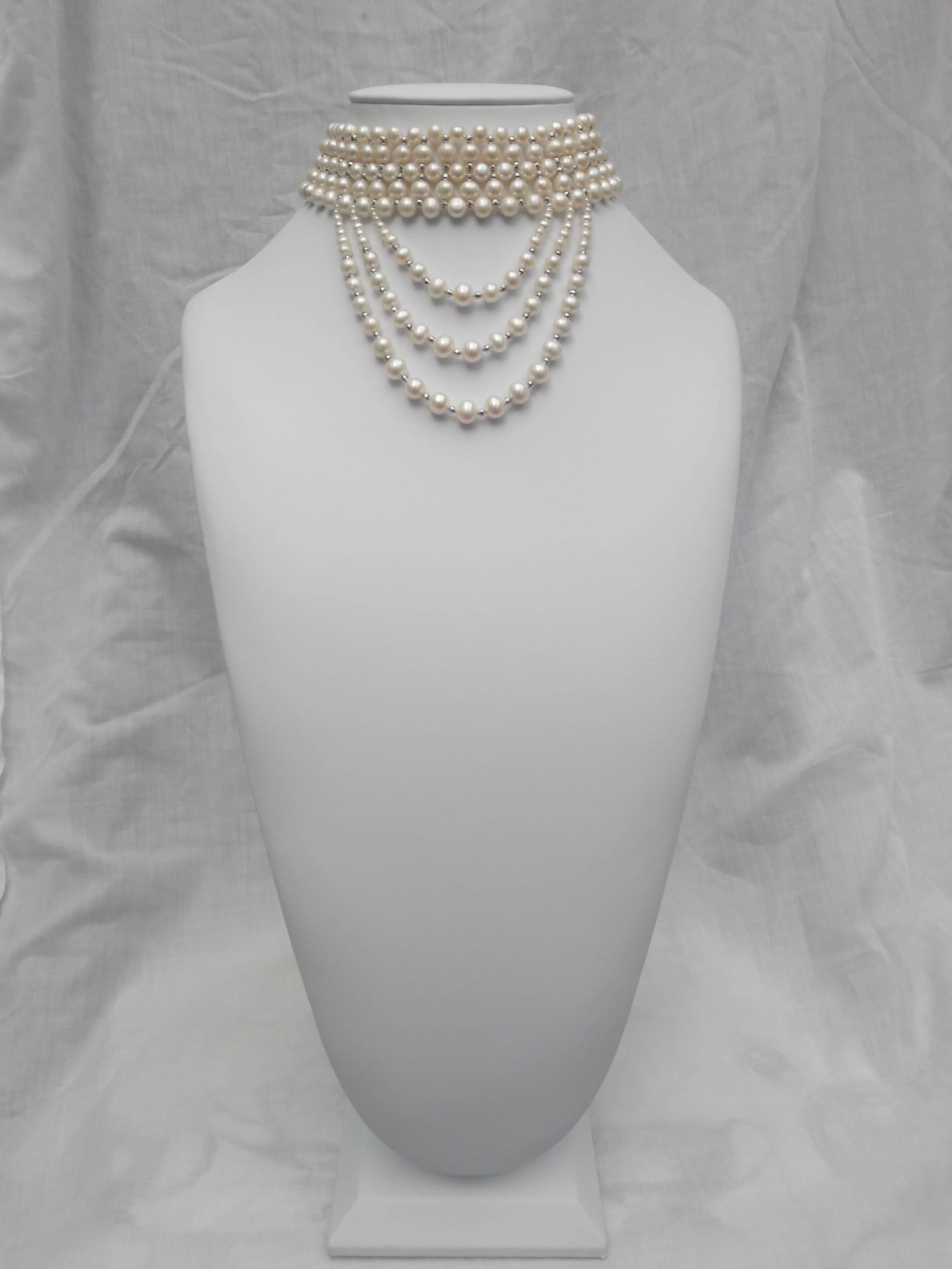 This striking draped choker features 5mm- 7mm white pearls beautifully woven with rhodium-plated silver faceted beads, and completed with a rhodium silver clasp. Emerging from the choker, are three elegant graduated white pearl and white gold