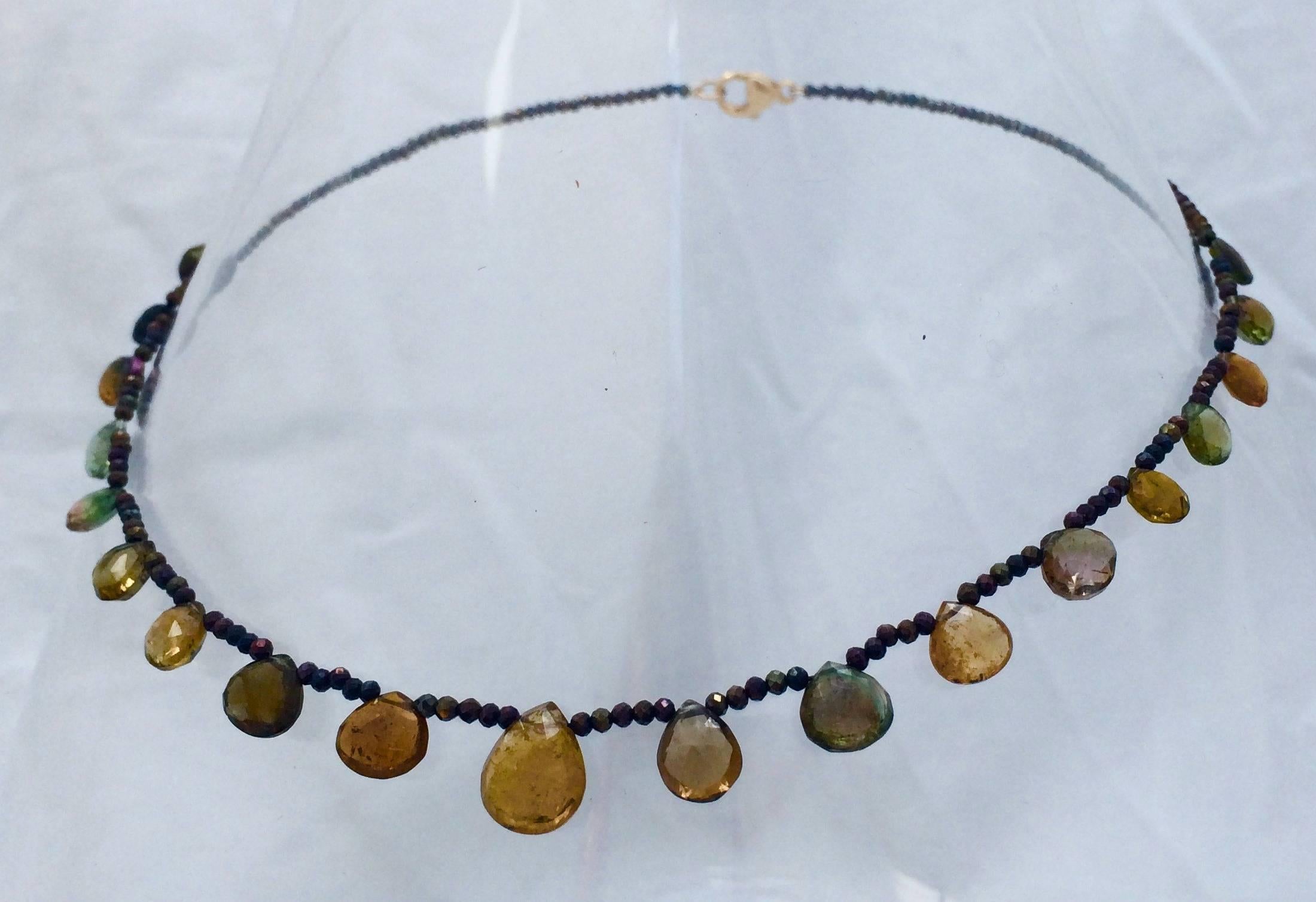 Elegant and understated.

Faceted Golden-hued Spinel beads are gently graduated into a tight strand. The strand is decorated with faceted/ multi-colored/ teardrop Tourmaline briolettes. The middle briolette is slightly larger than the surrounding
