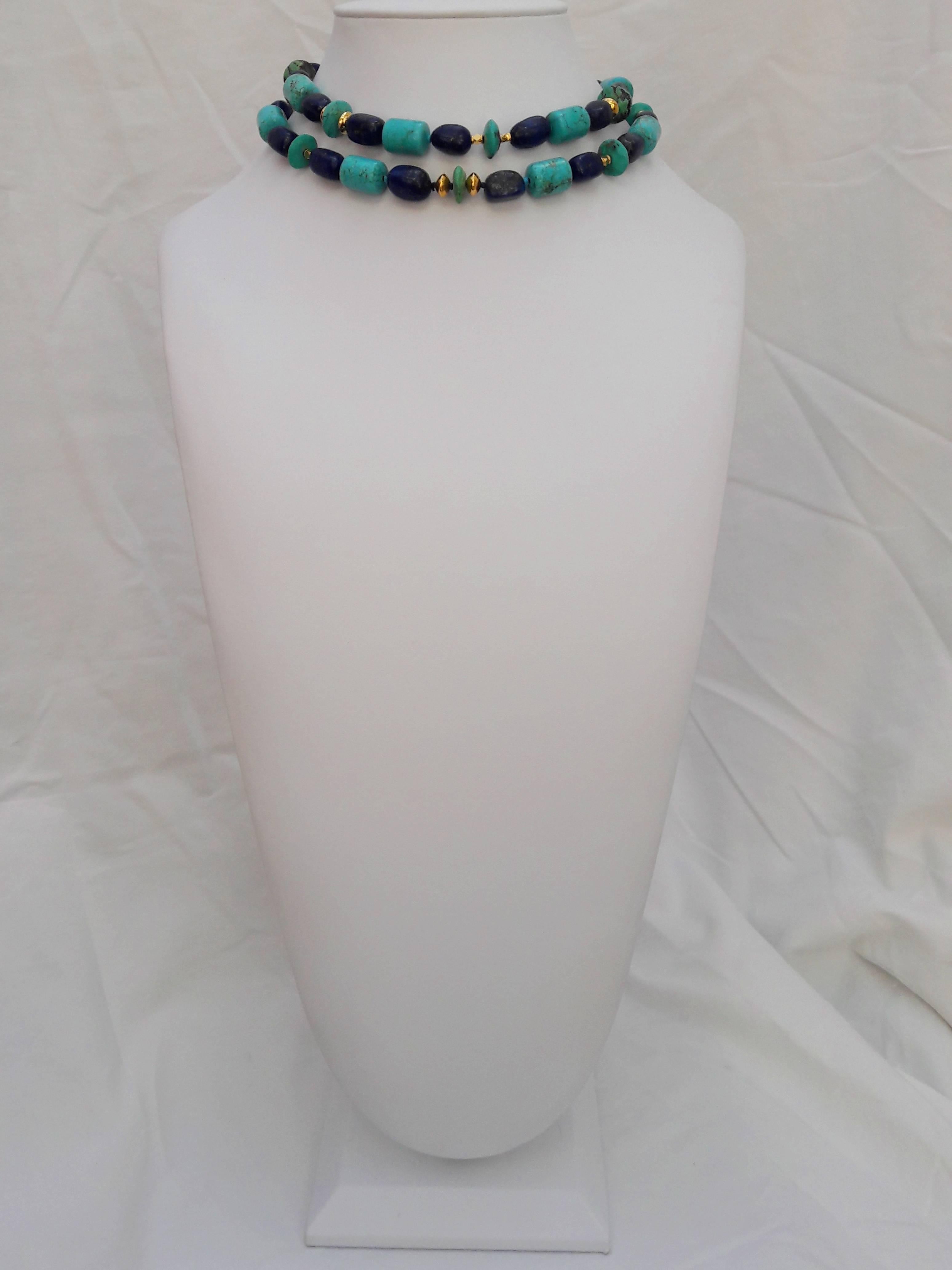 Odd and asymmetrical beads of turquoise and lapis are composed in a matched pattern of color and dimension. Sections of dark and light blue are punctuated with silver (gold-plated) beads that accentuate the contrast of the beads. This long lariat