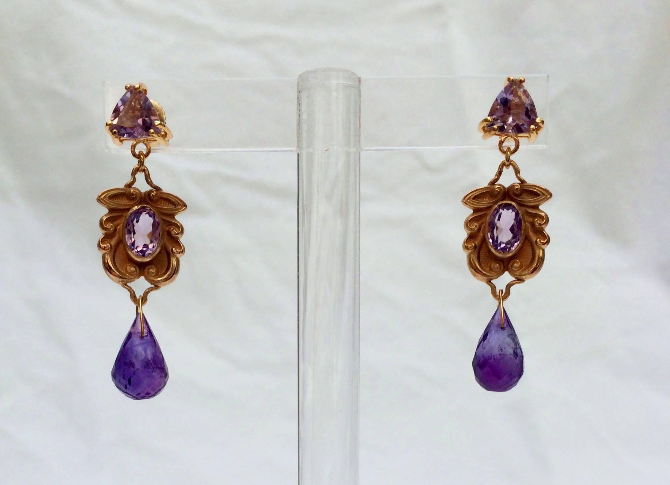 At the top of these unique and vibrant earrings is the stud and stone setting, made from 14 K rose gold, and of original Marina J design. The setting houses a faceted, triangular cut Amethyst stone. The center of the earrings are vintage 14 K Rose