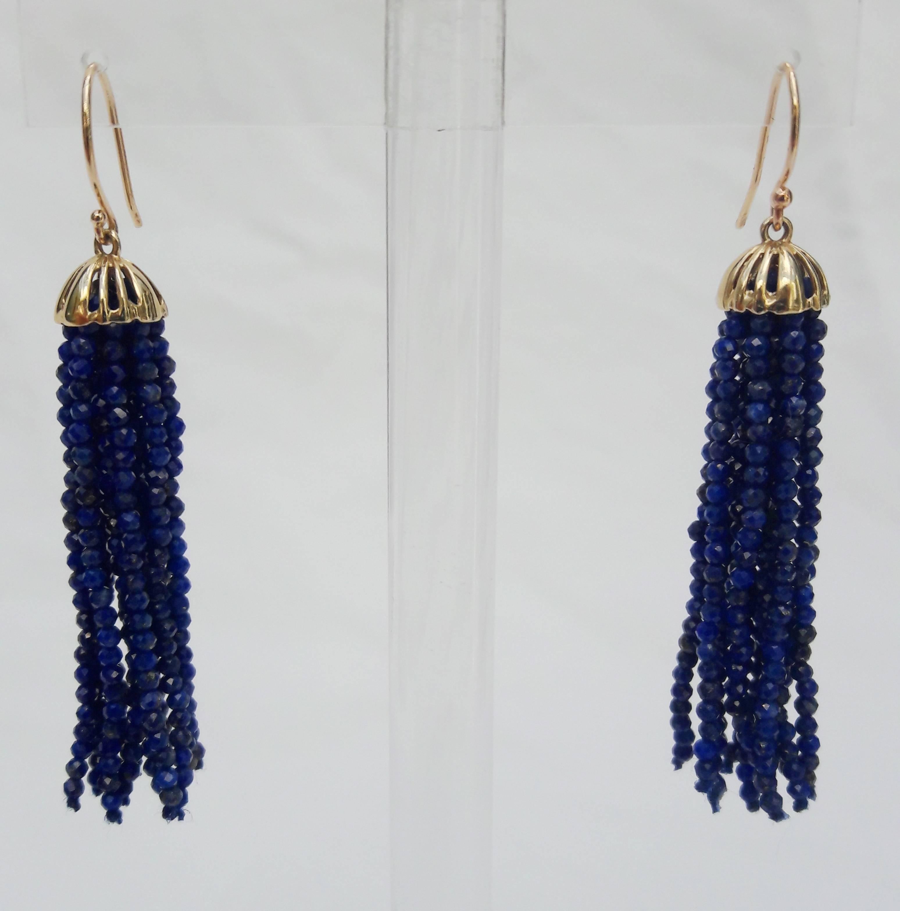 Vivid and timeless.

These unique earrings are composed with the finest 1 mm faceted Lapis-lazuli beads stranded to tassels. The tassels flow out of a 14 K yellow gold cup, connected to a fine 14 k gold hook.

End to end measures 2.5 inches