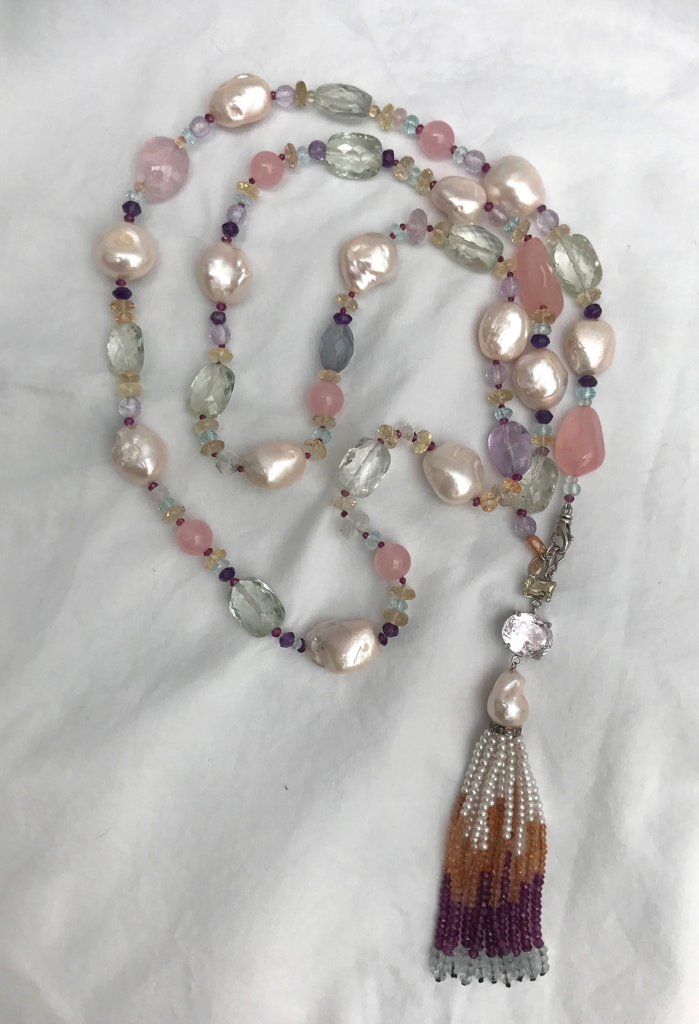 Long necklace with large Baroque Pearls, Amethyst, Citrine, Blue Topaz, Aquamarine, Pink Quartz and Fluorite beads create a gorgeous shimmering piece. The semiprecious stones highlight the luster and iridescence of the pearls, unifying the colored