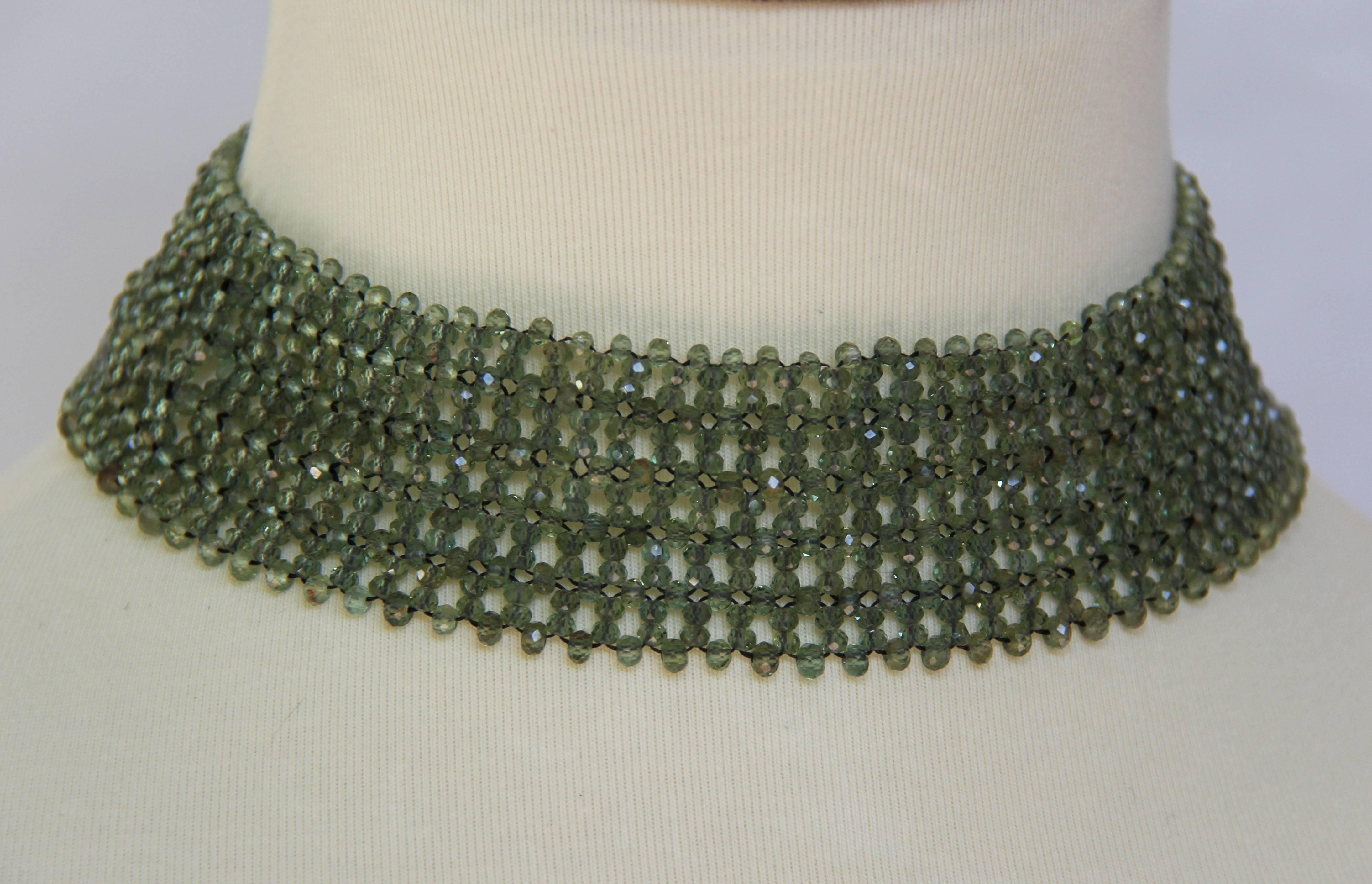 Faceted Green Apatite  beads woven into an elegant 1 inch wide and 13.5 inch long choker necklace. with intricate pattern that glimmers and sparkles in any light. A turn of the century Sliver Gold-plated pin with enamel inlay attached to silver 14k