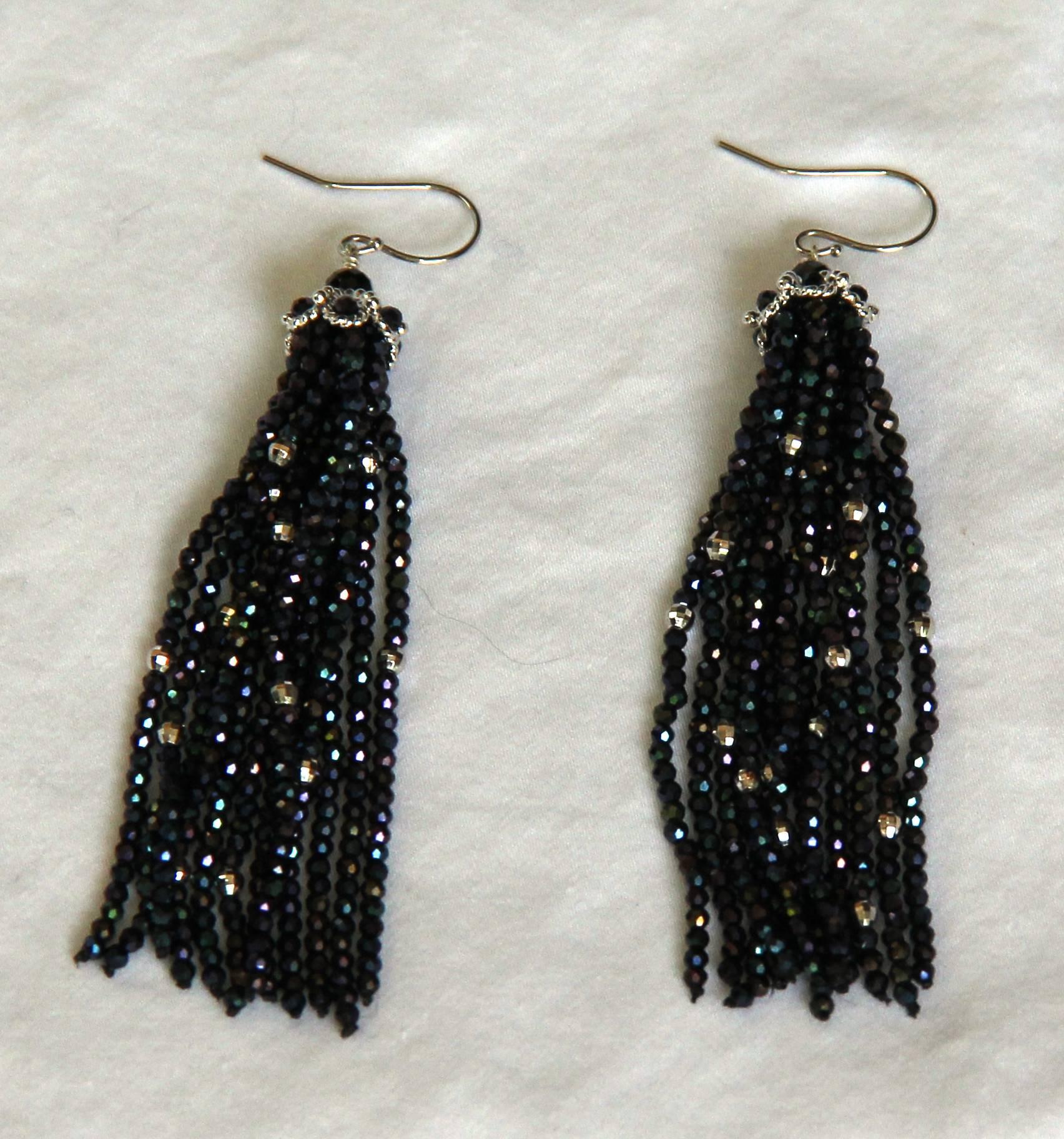 These lush and shimmery faceted Black Spinel and faceted white gold-plated beads earrings are like a dance of light and shade, 

Contrasting with the deep dark color of the beads is platinum plated silver filigree cups and 14 k white gold ear-wire.