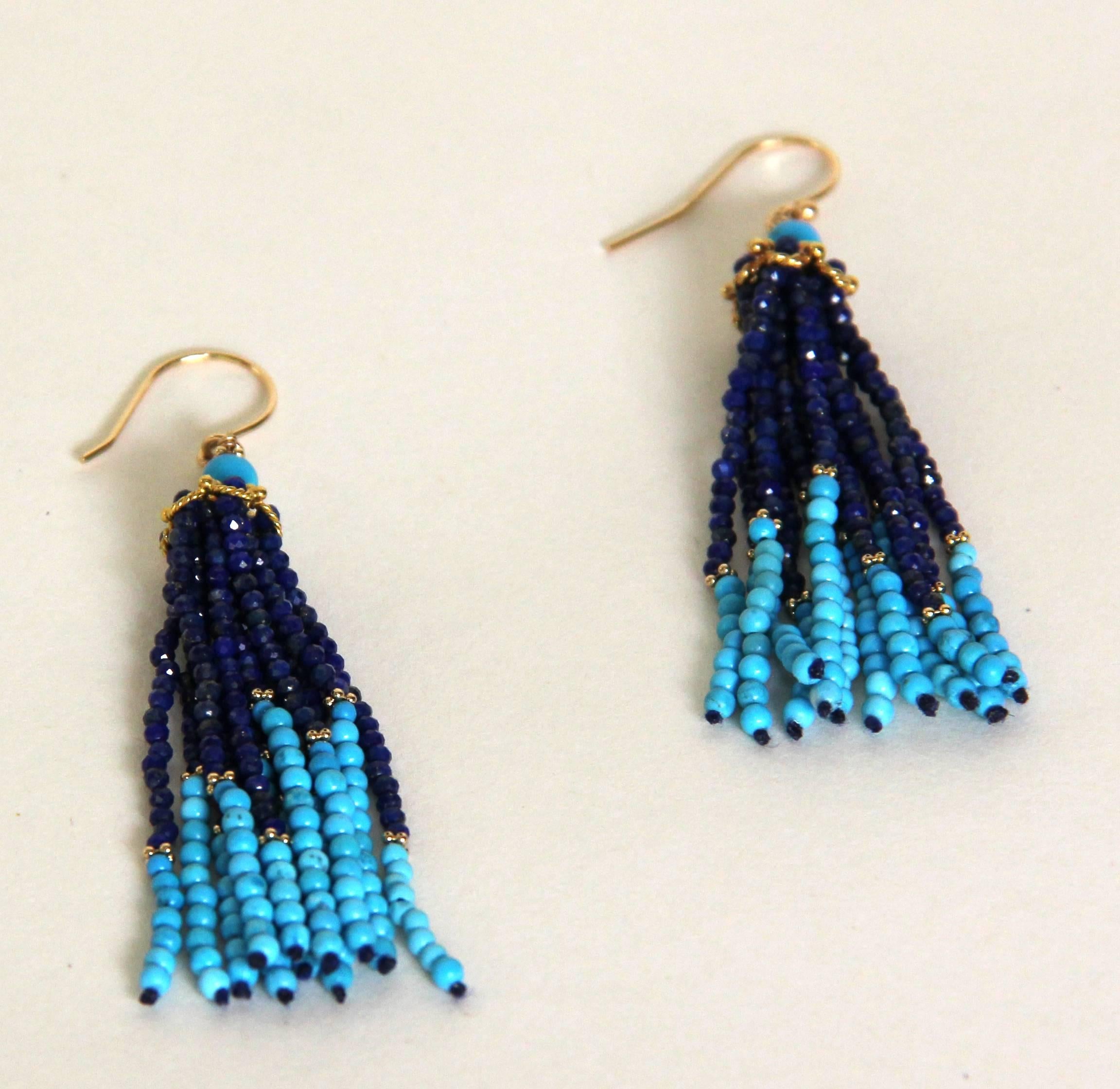 These elegant tassel earrings by Marina J, are topped by a round Turquoise bead and a unique 14 karat gold piece, through which  strands of faceted Lapis  and Turquoise beads are threaded. The ear wires are also 14 karat gold. These 3 inch tassel