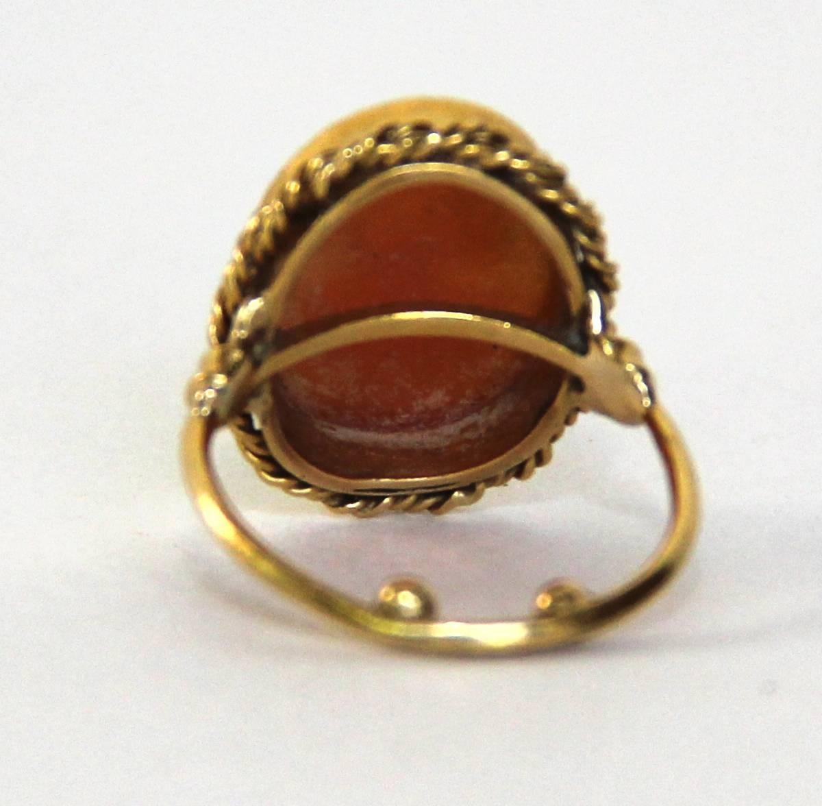 Russian turn of the 20th century 18mm carnelian cameo with hand-carved ballerina, set in 18 karat (not stamped) gold. Two gold balls at the bottom of the ring prevent it from turning. Ring size 6 3/4