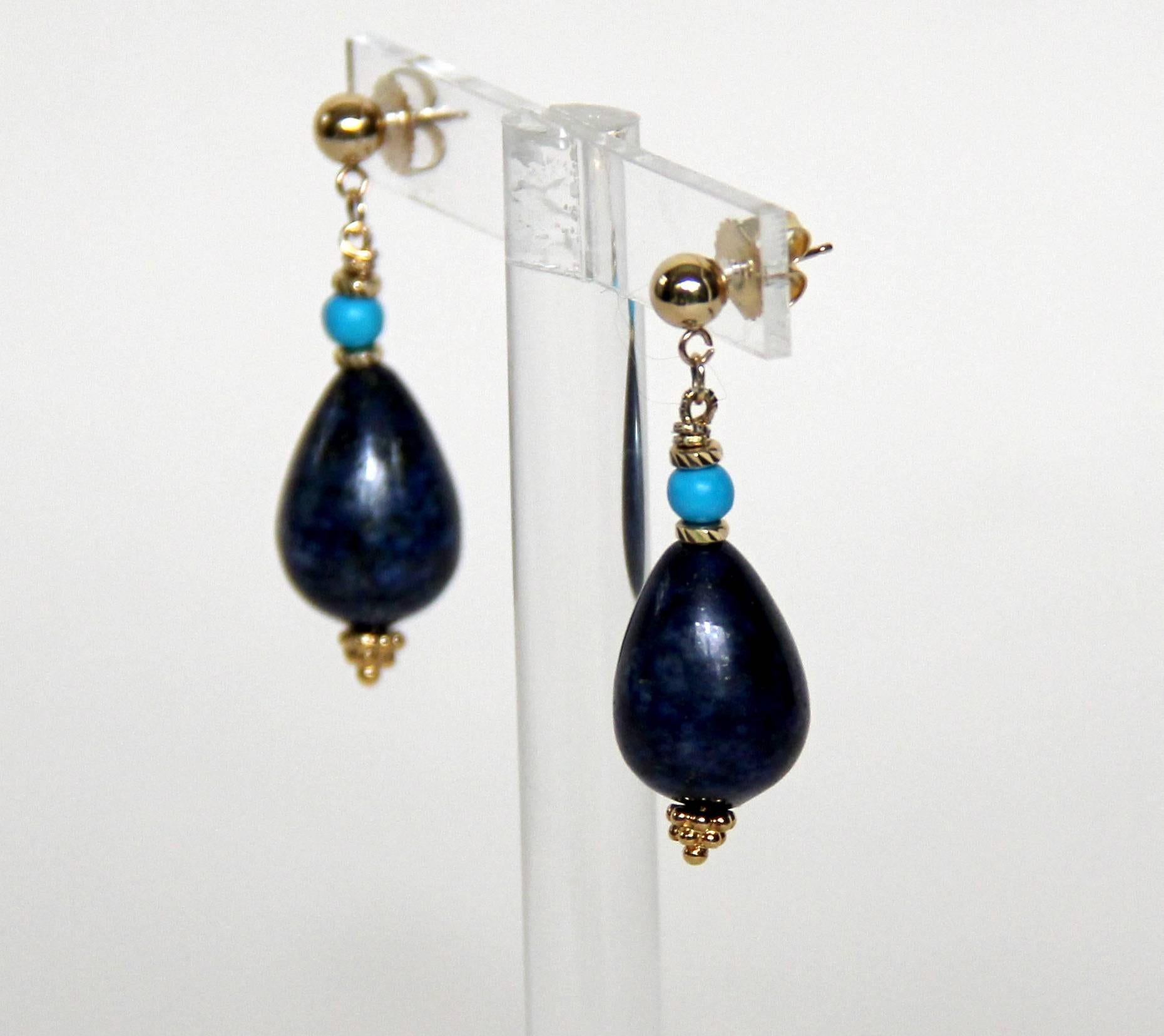 This elegant earrings showcase a centerpiece of 20 x 12 mm pear-shaped solid  Lapis Lazuli accented by 14K yellow gold and turquoise bead. This elegant composition is held by 14K yellow gold ear-studs.
Each earring is 1.5 inch long.