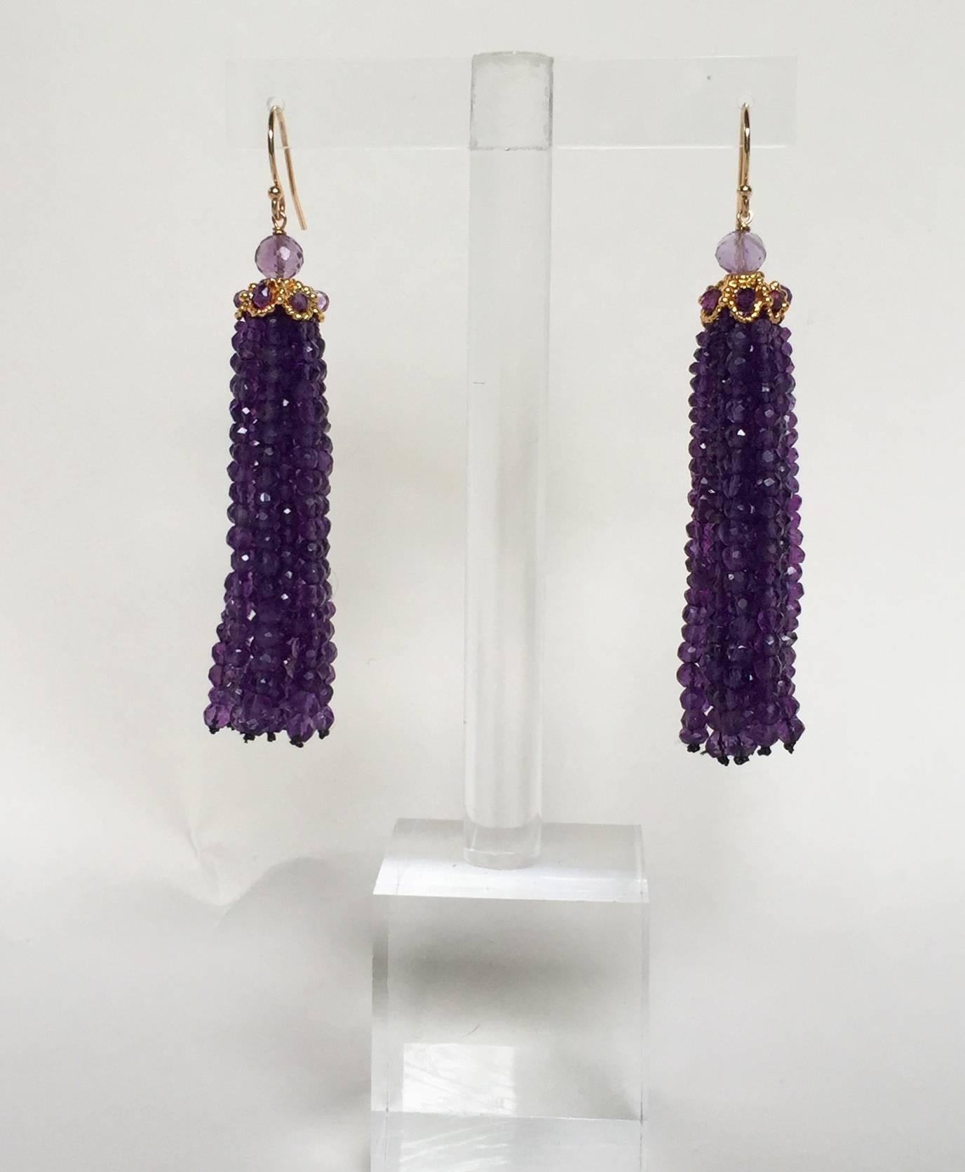 These unique earrings are composed with the finest 2.5 mm faceted dark Amethyst beads stranded to tassels. The tassels flow out of a 14 K yellow gold plated cup,encrusted with Amethyst beads connected to a fine 14 k yellow gold earrings.
Contrasting