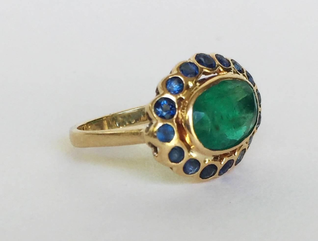 This pinky ring is made vibrant with its emerald and sapphire stones. The colors of the stones are accented with a 14K yellow gold band. It sits perfectly on the finger to highlight the energy and playfulness of the wearer. 
Ring Size: 5