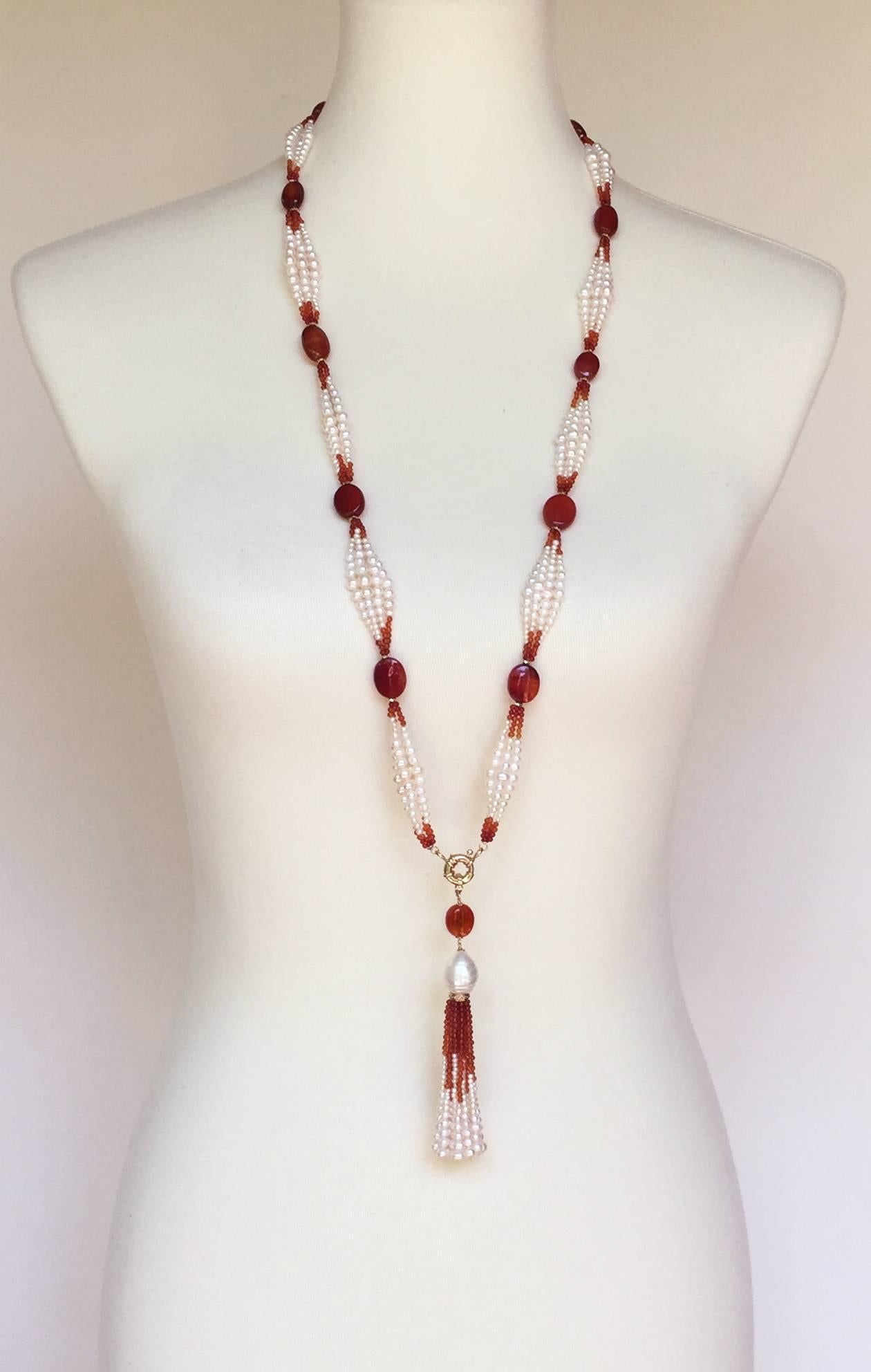 This elegant pearl and carnelian sautoir is a statement piece with the graduated pearl (1mm-4mm) and dark to light carnelian beaded design. The ombre design is highlighted by the large vibrant carnelian beads. Each large carnelian bead is embraced