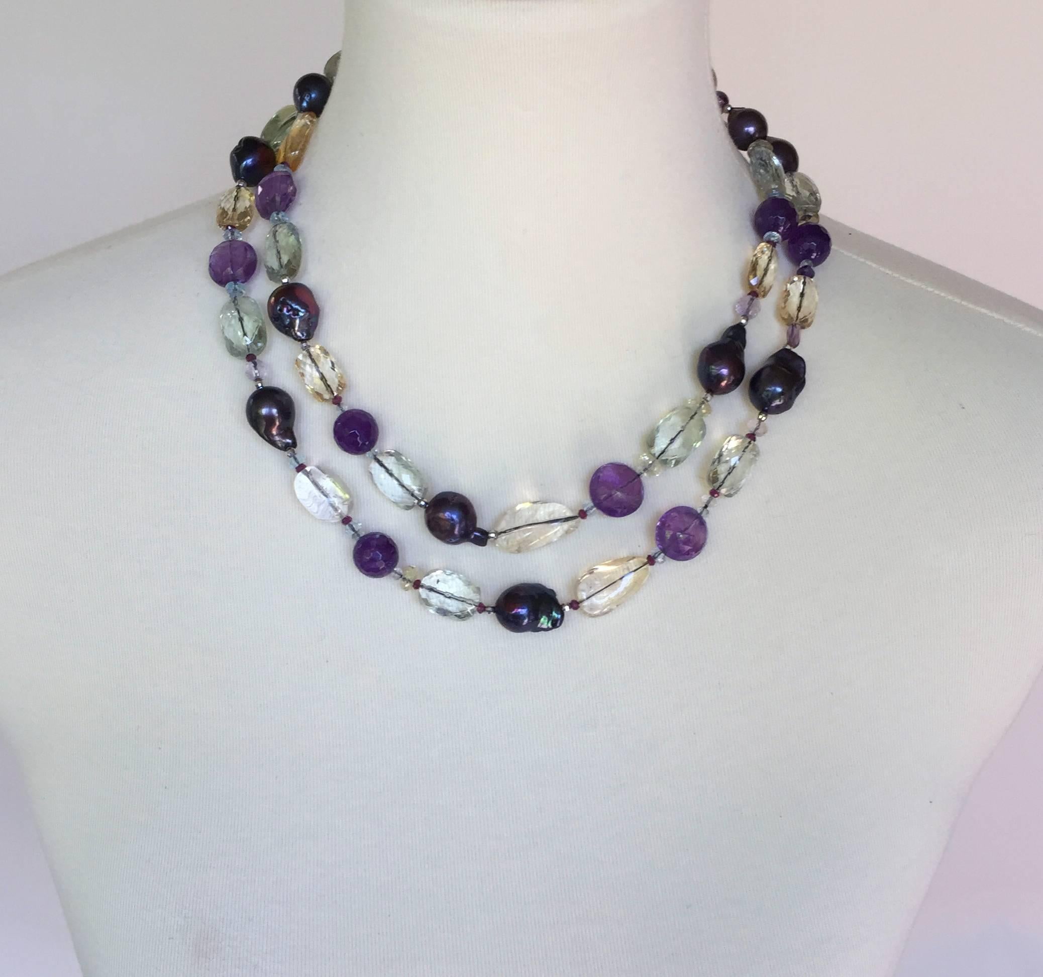 Large Baroque black pearls are paired with Citrine, Amethyst, Aquamarine, and Blue Topaz faceted and nugget beads to create a gorgeous shimmering piece. The colored stones highlight the luster and iridescence of the cultured pearls, unifying the