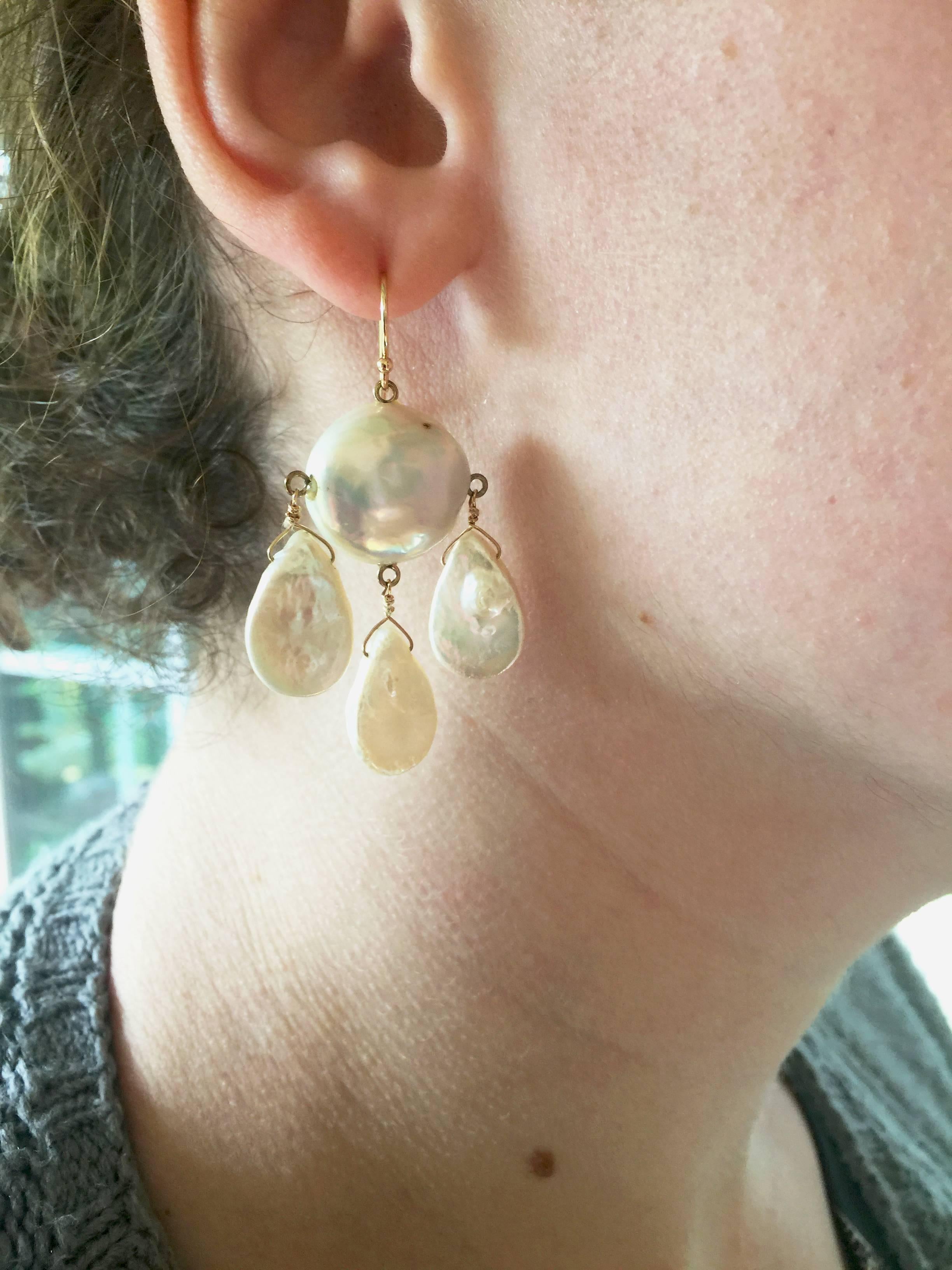 Three flat drop pearl hang a large baroque pearl by 14k gold wiring, make a bold statement perfect for the holidays. The imperfections of the earrings are what make these earrings one of a kind and catch the light, making them glisten as if still in