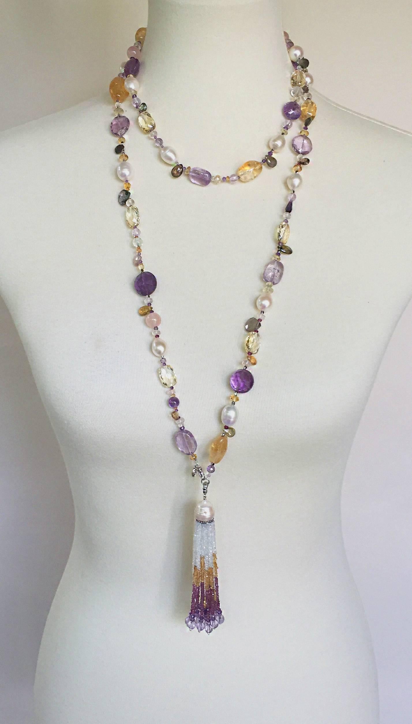 This extra long sautoir has a variety of wearable options as seen in photos. The light and elegant tone is highlighted by the shimmering colors of the amethyst, citrine, garnet, tourmaline, aquamarine, and topaz beads.  Tear drop stones are woven