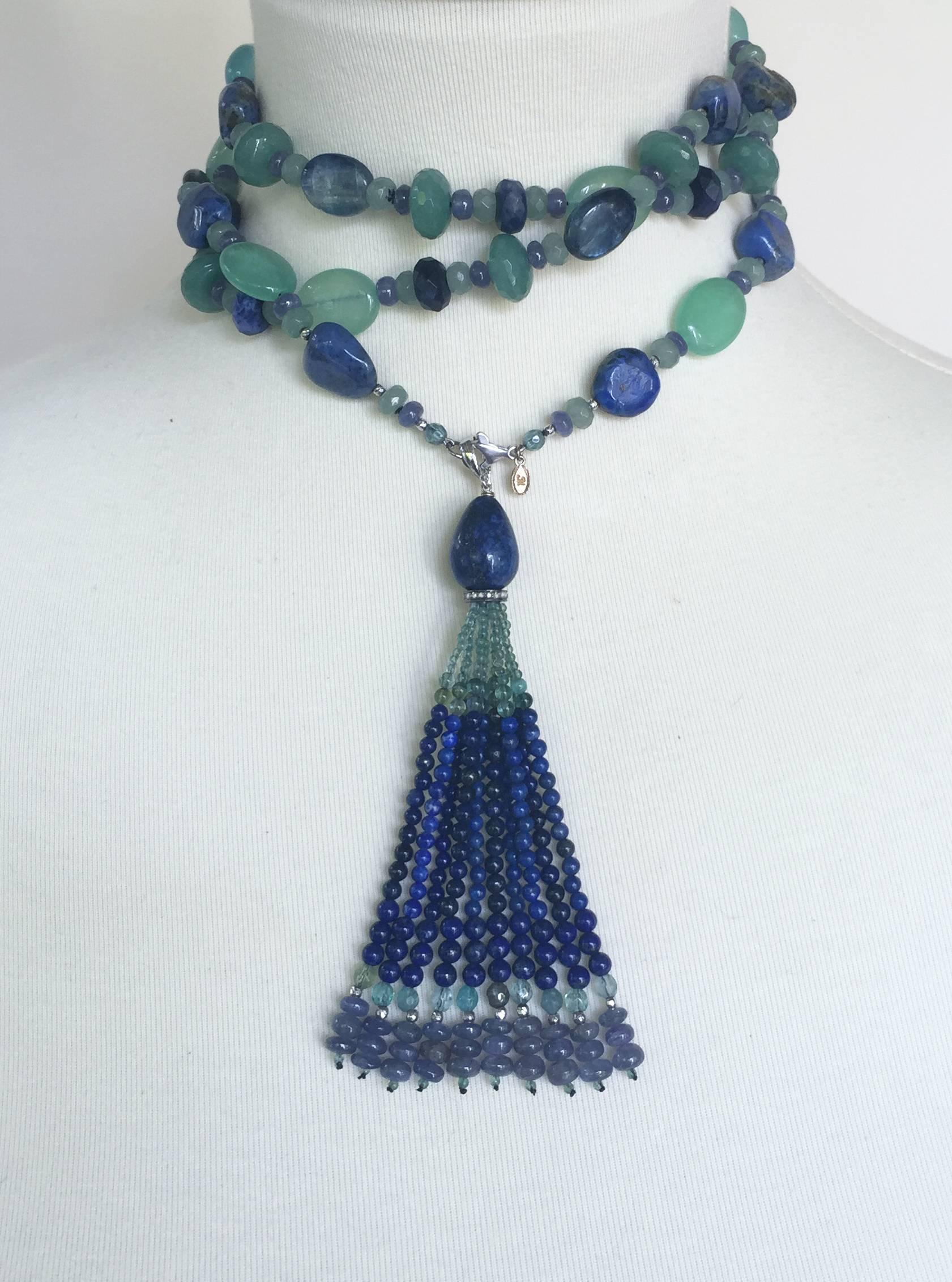 The dynamic blue and green colors come from the different shades and cut of Lapis Lazuli, Sapphire, Tanzaninte, Blue Apatite, Agate, Kyanite, Aventurine, and  Laboradite stones, highlighted by 14k white gold beads and findings. The tassel (4.5