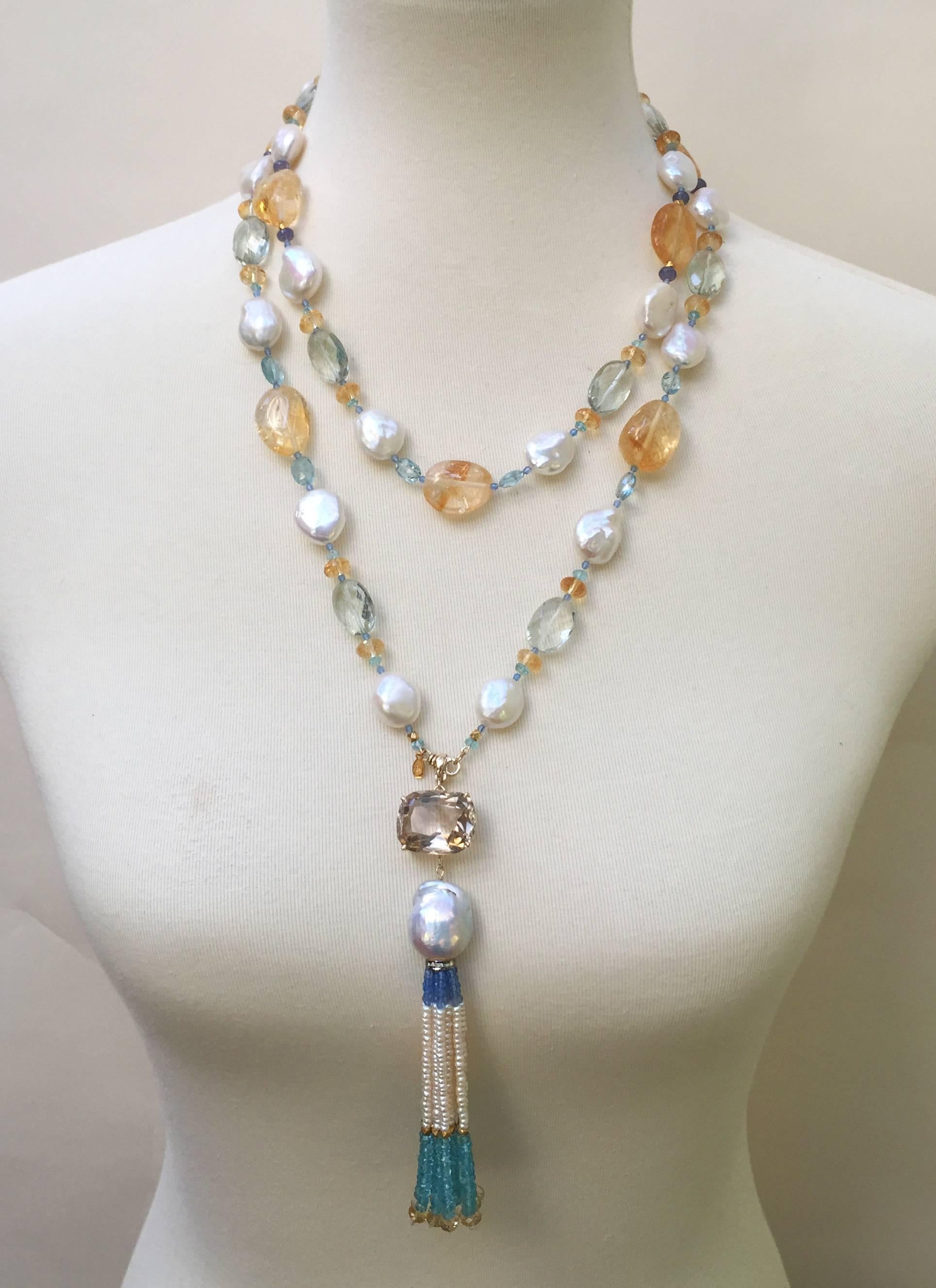 This blue and yellow hue sautoir is composed of aquamarine, smokey quartz, blue agate, green amethyst, citrine, blue topaz, pearls, and tanzanite beads that of different sizes and a mix of faceted and smooth textures. The different textures and