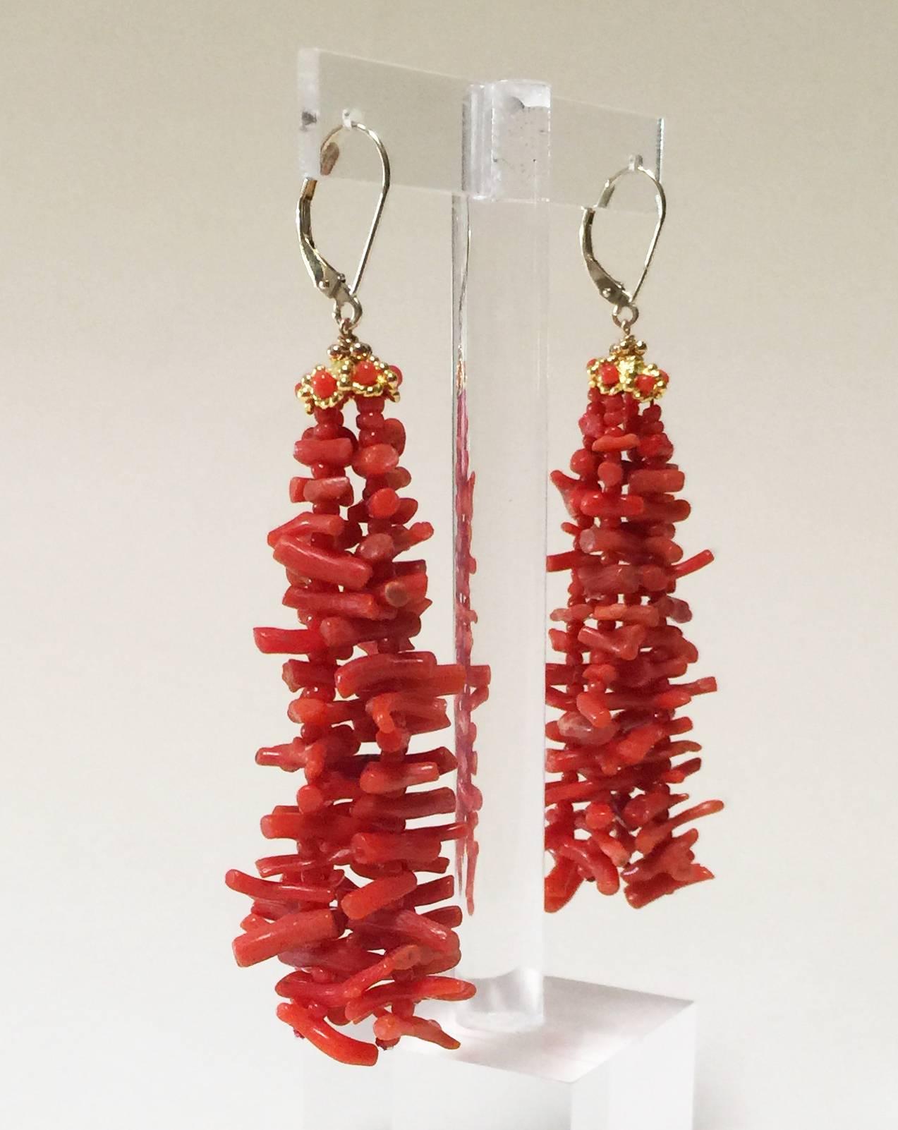 These coral tassel earrings are dynamic and vibrant. At 3 inches they frame the face perfectly. Each strand has a graduated pattern of and elongated coral bead and small round coral bead to create a gorgeous and elegant composition. On top of the