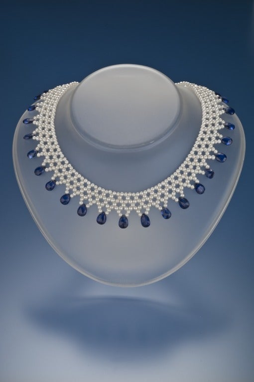This handwoven. multi-strand necklace is made of 2 mm pearls, carefully selected for quality and luster. The faceted Kyanite briolettes are teardrop-shaped, and their deep and intense blue pop out next to the smooth and milky pearls. 

The secure