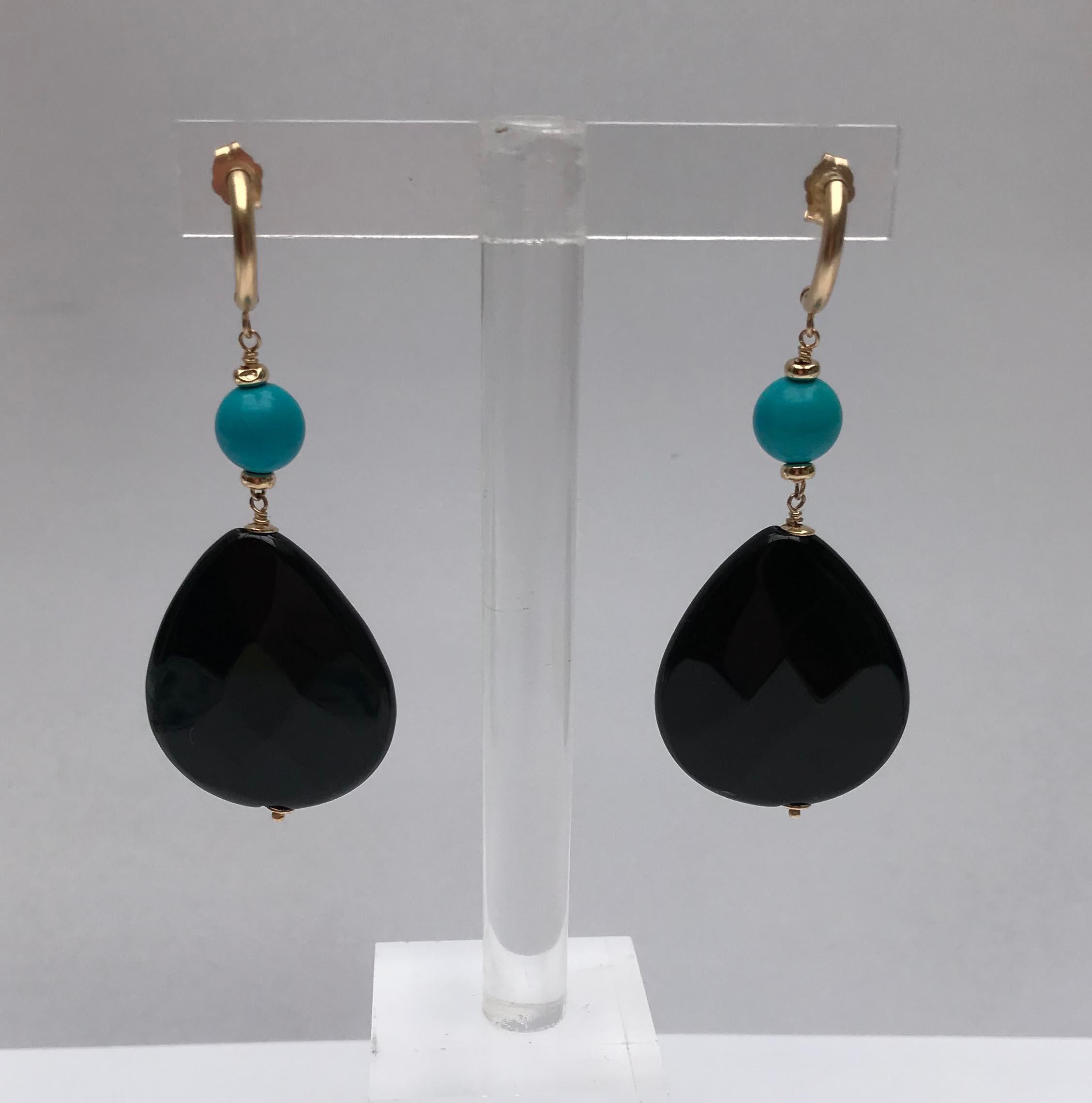 Marina J. designs presents a turquoise and onyx earrings with 14k yellow gold stud. These beautiful stoned earrings make a bold statement with the large drop shape onyx bead and also gives vibrant color with the turquoise. The earrings are