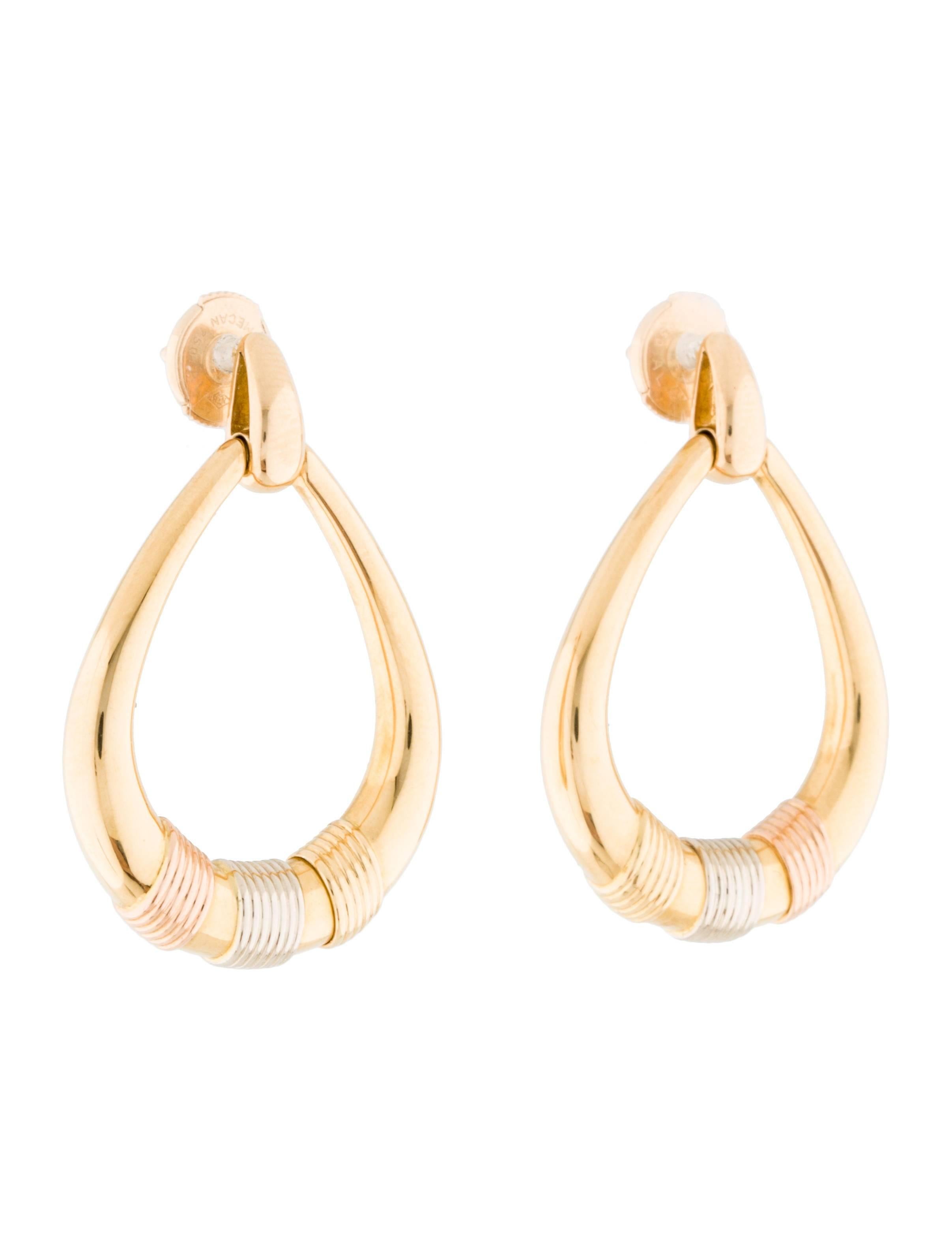18K yellow gold Cartier Trinity drop earrings with 18K yellow, white and rose gold ridged motif accents and clutch back closures.

Metal Type: 18K Yellow Gold, 18K White Gold, 18K Rose Gold
Hallmark: 750, Brand Hallmark, Serial Number
Signature: