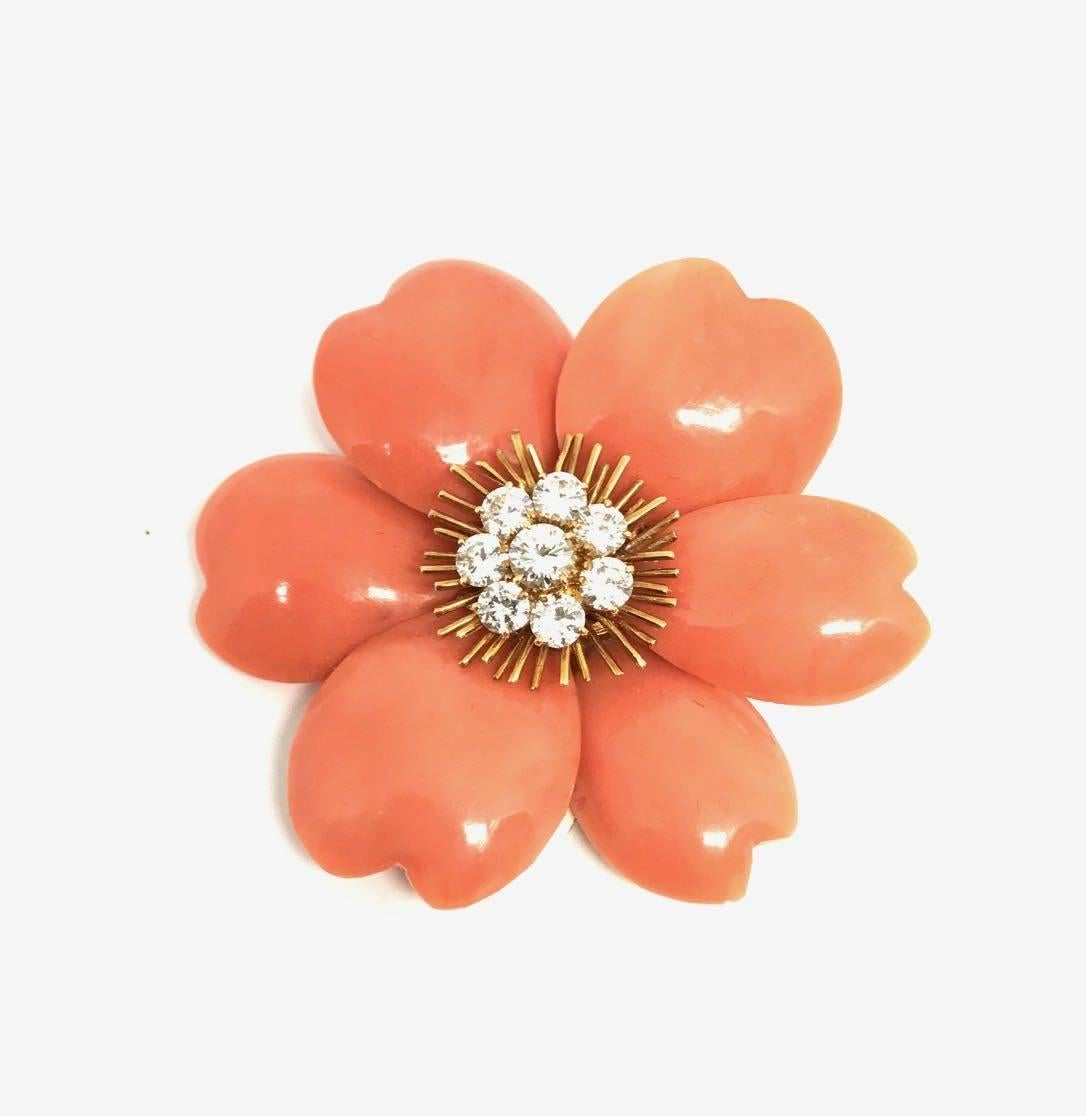 Synthesis of virtuoso savoir-faire, Rose de Noel is one the most iconic Van Cleef and Arpels models. Symbol of romance and beauty this particular model is made with exquisite  coral and diamond. Rare and precious this set (brooch and ear clips) 