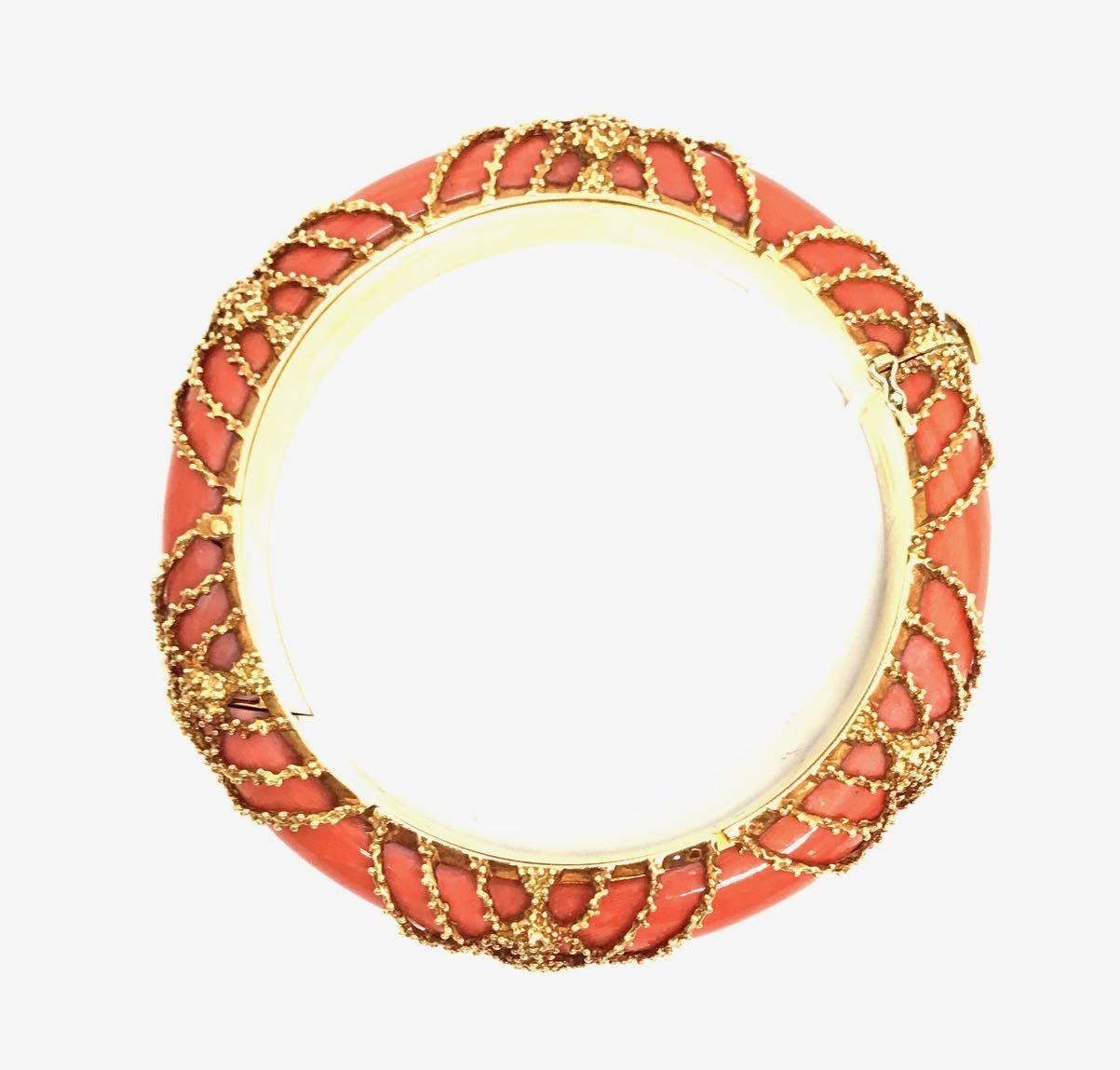 An exquisite and bold  coral bangle overlaid with textured netted gold. 

This extraordinary bangle was made by famous Parisian house  Van Cleef & Arpels in the mid 1960's. 

A real show stopper for a woman with refined taste. 

Signed and