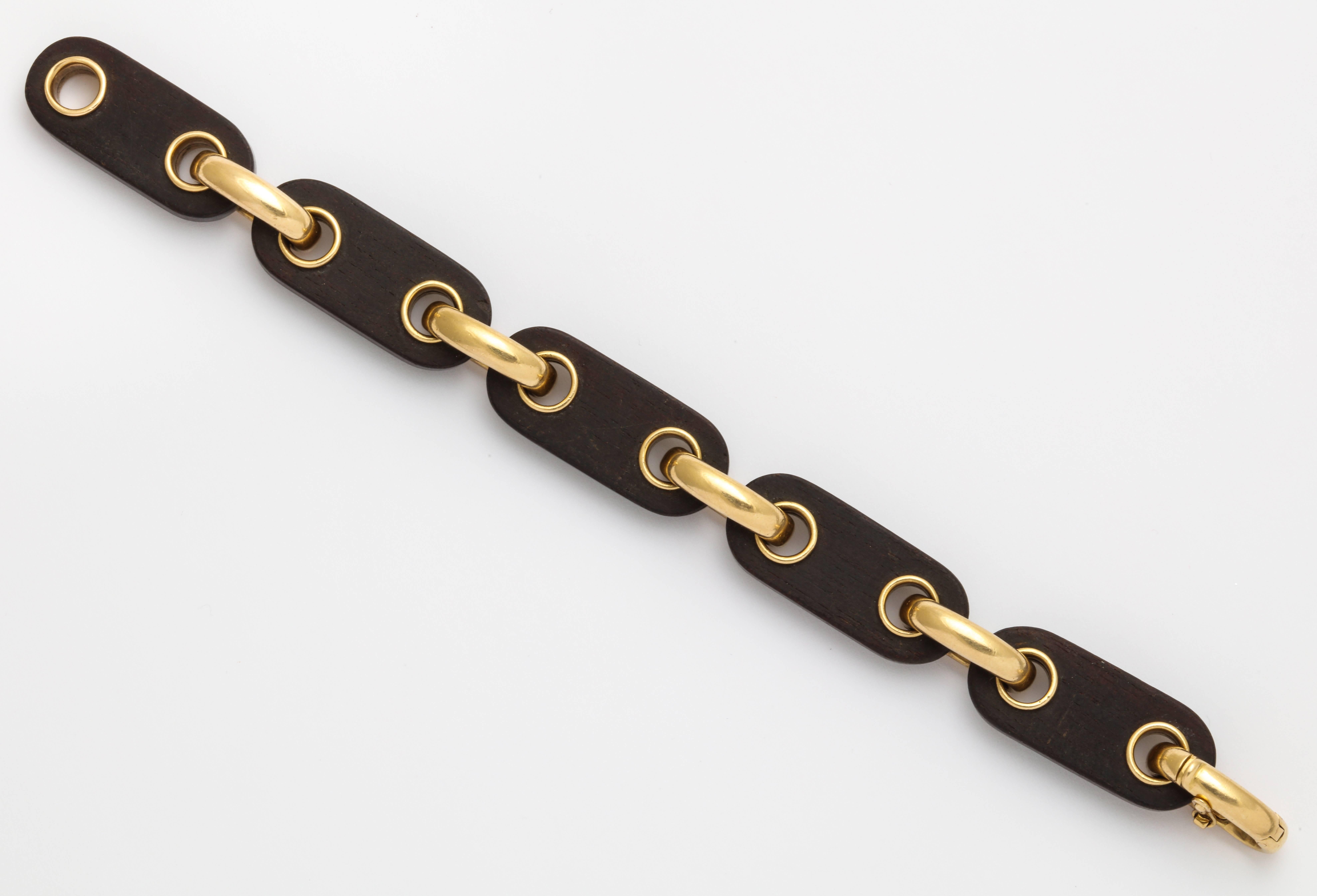 Duality, soft and strong. 
This bracelet is the perfect companion for a strong woman with a soft spot. 
Made in the mid 60's is a great ad on to a sophisticated wardrobe . 
Made in wood and 18k Yellow gold this brancelet has been made by the french