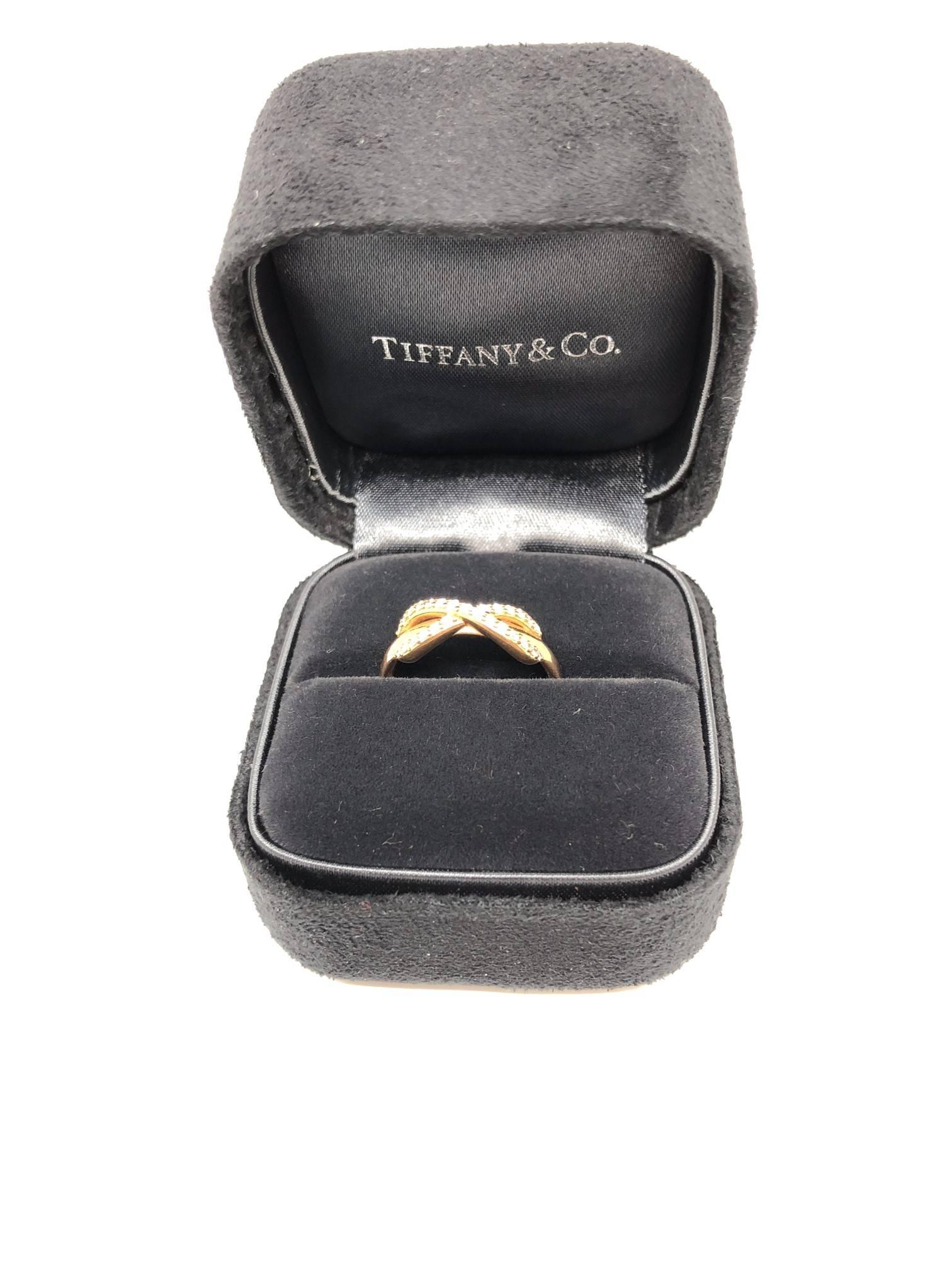18k rose gold Infinity ring from Tiffany & Co. The diamonds loop around the band to create an elegant infinity symbol, signifying a continuous connection or energy.

18k rose Gold band with round cut diamonds.

Ring Size 4 1/2