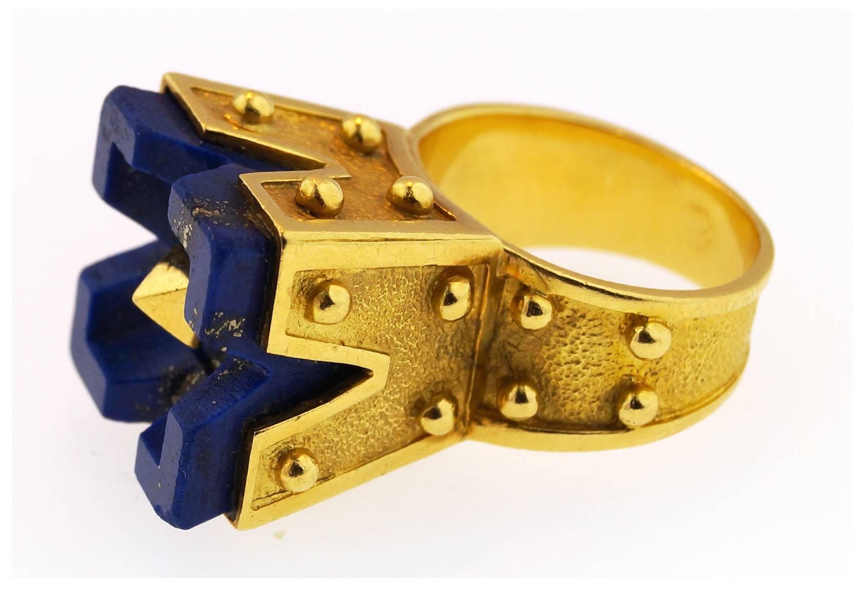 This gorgeous ring was designed by Aldo Cipullo for Cartier in the 1970's. This fantastic and bold ring is crafted in 18K yellow gold and set with a blue lapis lazuli. 
This ring made in France and measures size 6. 