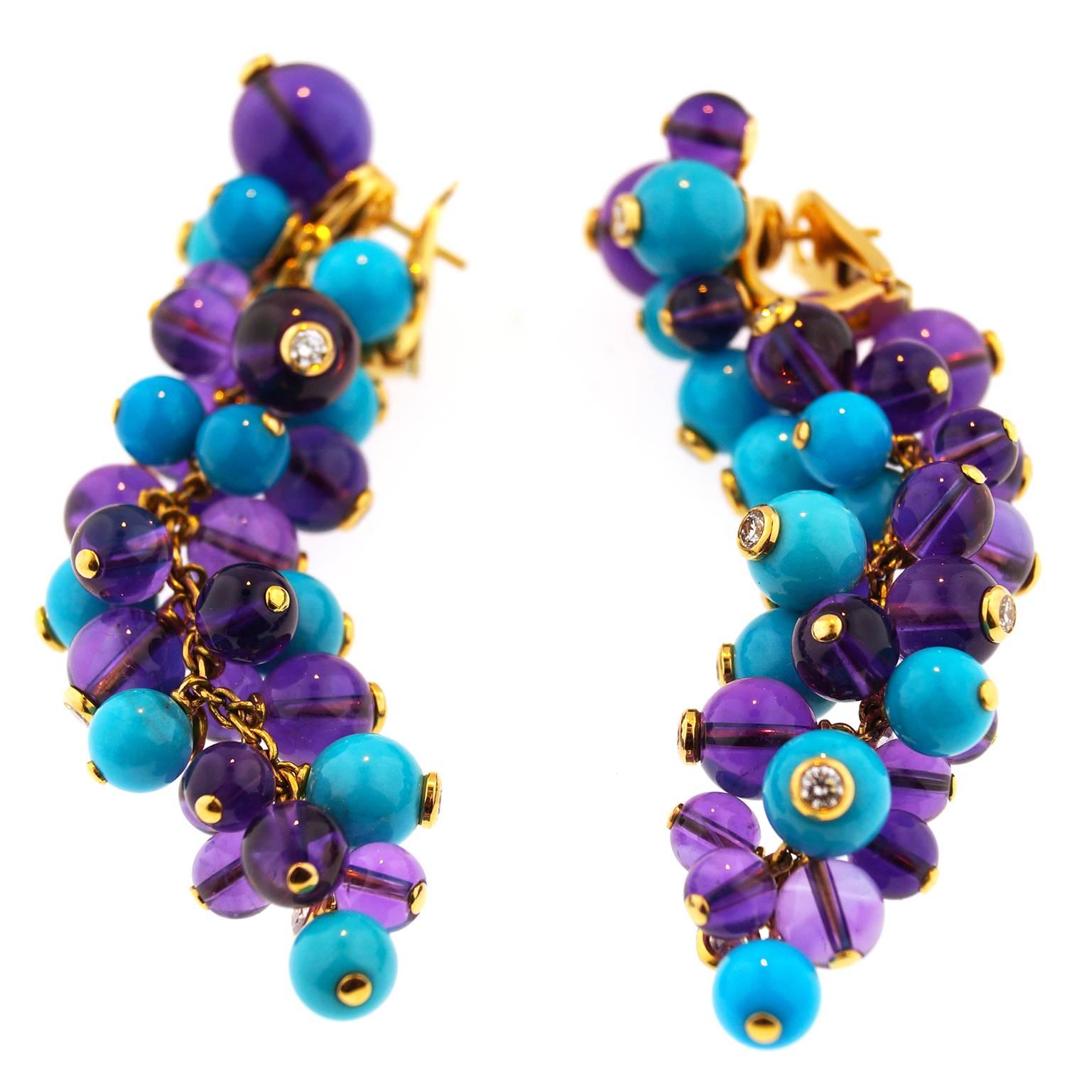 These dangling earrings from Cartier's Les Delices de Goa collection is made in 18k yellow gold and features a cluster of 11 Turquoise beads and 20 Lapis Lazuli beads accented with 12 solitaire diamonds. 
This fantastic  rare pair of earrings  is