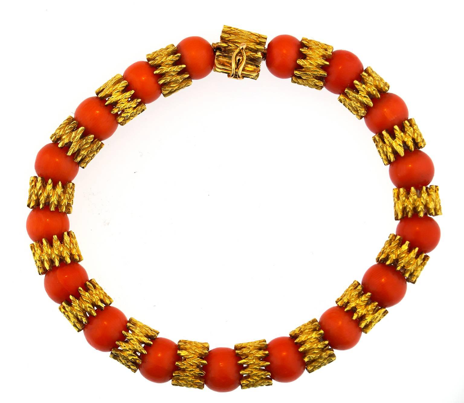 This beautiful vintage Hans Stern 18k yellow gold bracelet  boasts 17 coral wonderfully matched coral beads. 
A fun yet refined piece
