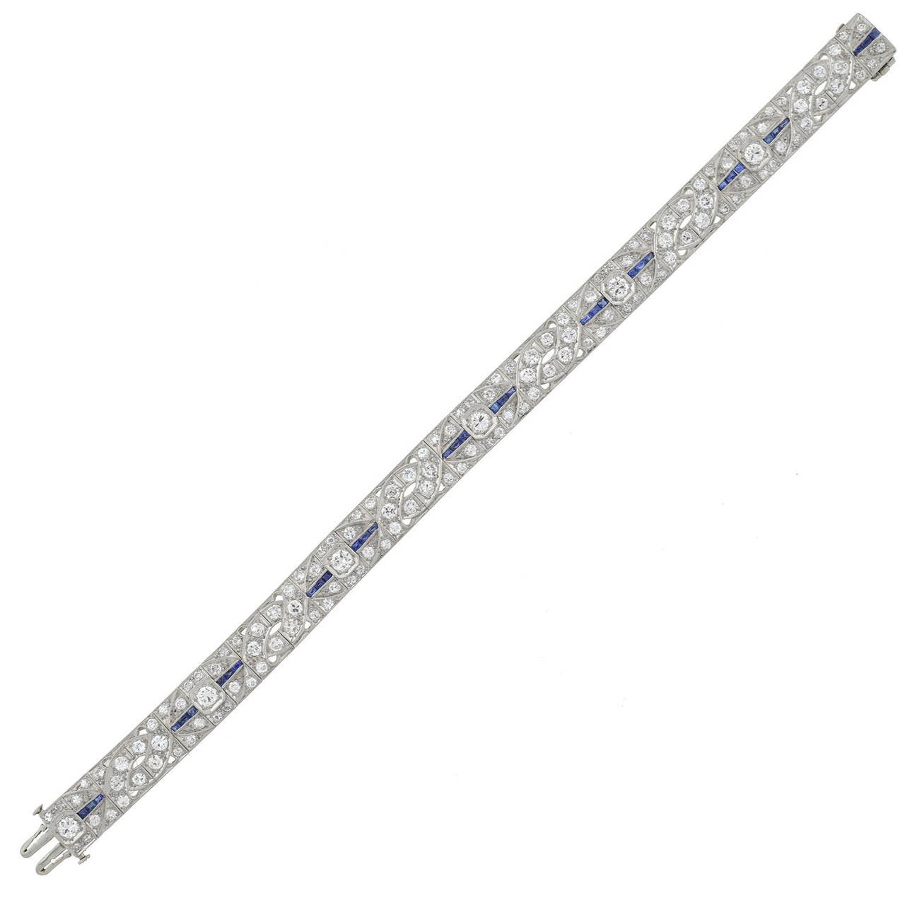 An absolutely stunning line bracelet from the Art Deco (ca1930s) era! Made of platinum, this gorgeous piece has approximately 5 carats of diamonds which have H/I Color and VS1-2 clarity and 1.25 carats of calibrated French cut sapphires. Comprised