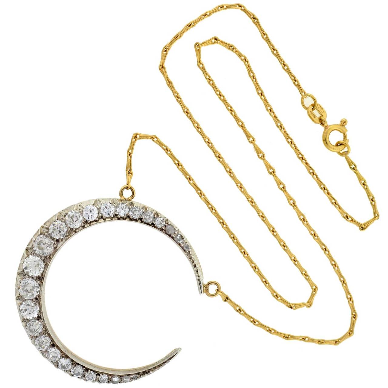 This diamond crescent necklace from the Victorian era (ca1880) is absolutely breathtaking! Made of sterling-topped 18kt gold, this gorgeous necklace is comprised of a single crescent moon pendant that hangs from a vibrant yellow gold chain. The