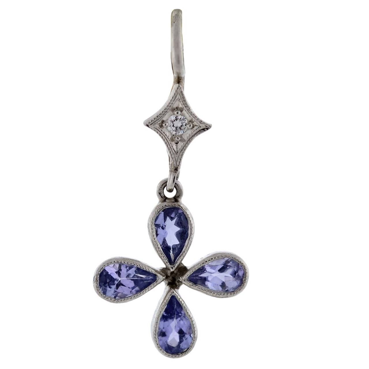 Tanzanite and diamond earrings from legendary maker Cathy Waterman. These gorgeous earrings are made of platinum and adorn 4 pear shaped tanzanite stones which form a dangling flower. The luscious, vibrant stones have a faceted face and pointed