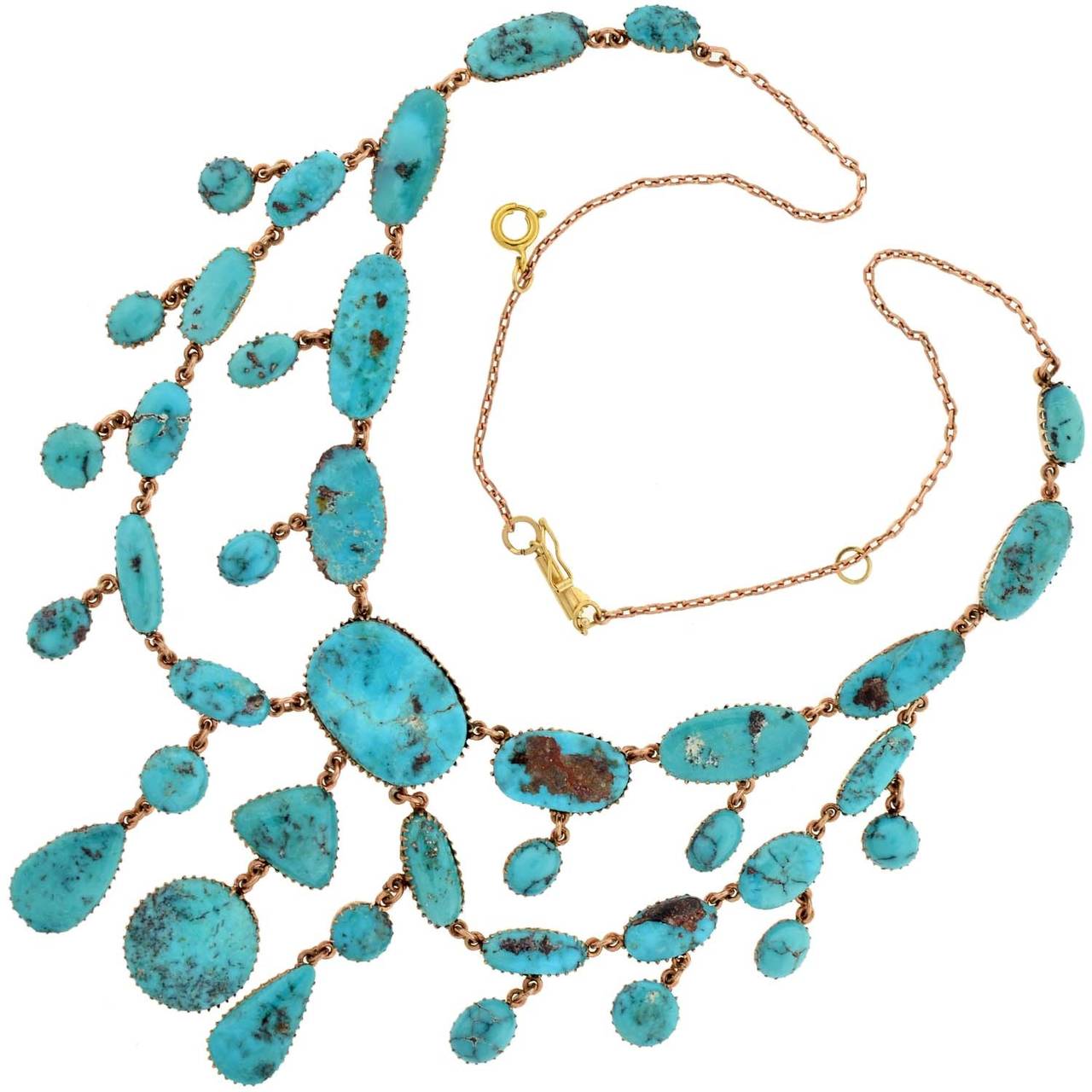 A beautiful turquoise necklace from the Victorian (ca1880) era! This lovely and feminine piece is set in 15kt rosy yellow gold and comprised of 39 vibrant turquoise stones of various sizes and shapes. Eleven stones line the neck of the piece and 28