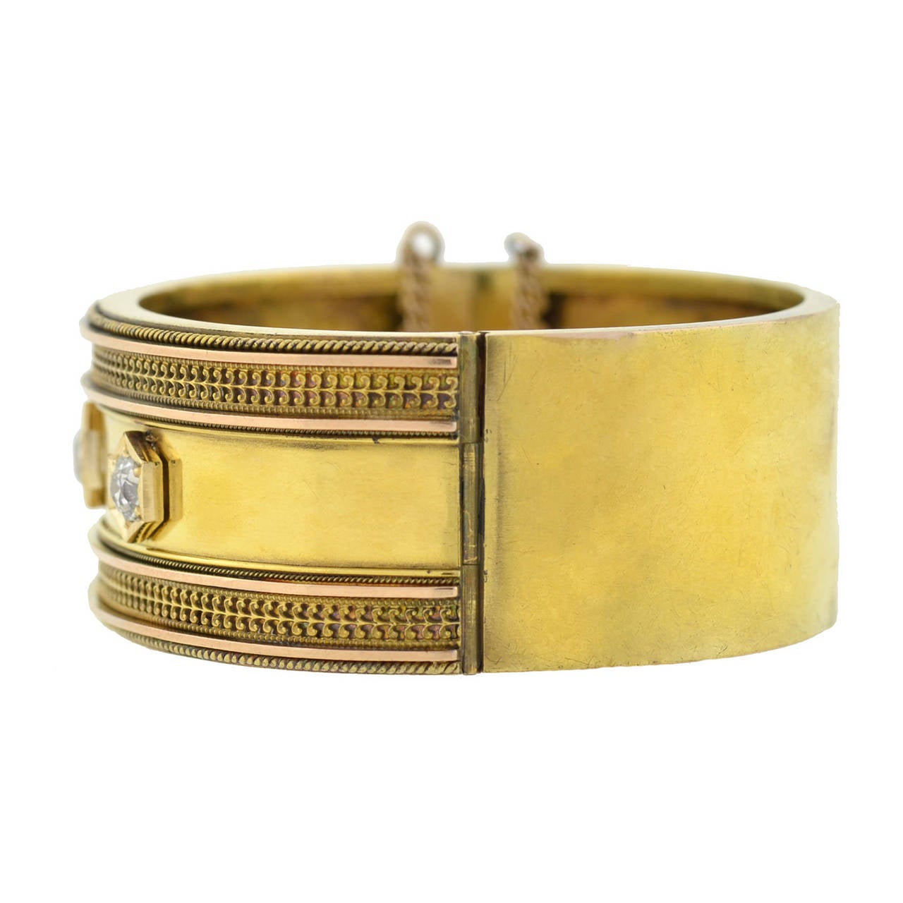 An outstanding gold bangle bracelet from the Victorian (ca1880) era! This wide hinged bangle is made of vibrant 15kt yellow gold (indicating English origin) and has a very fine Etruscan wirework design that borders the top and bottom edges of the