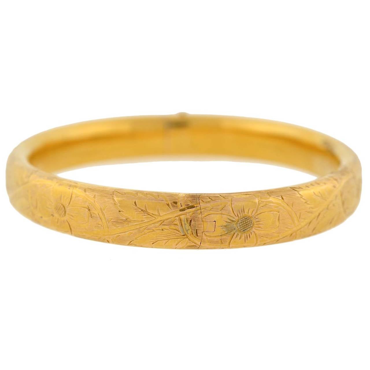 A gorgeous gold bangle bracelet from the Victorian (ca1880) period! This stunning piece is made of 14kt yellow gold and has a flowing floral etched design covering the entire outer surface. The beautiful etching adds texture and depth to the piece,