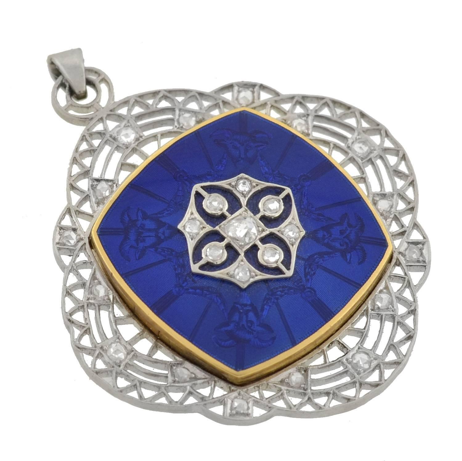 A simply magnificent Edwardian era (ca1910) piece with a fabulous and subtle detail! This locket has a stunning double-sided enameled surface with a very intricate and detailed design etched beneath it. The enamel center is set in 14kt yellow gold