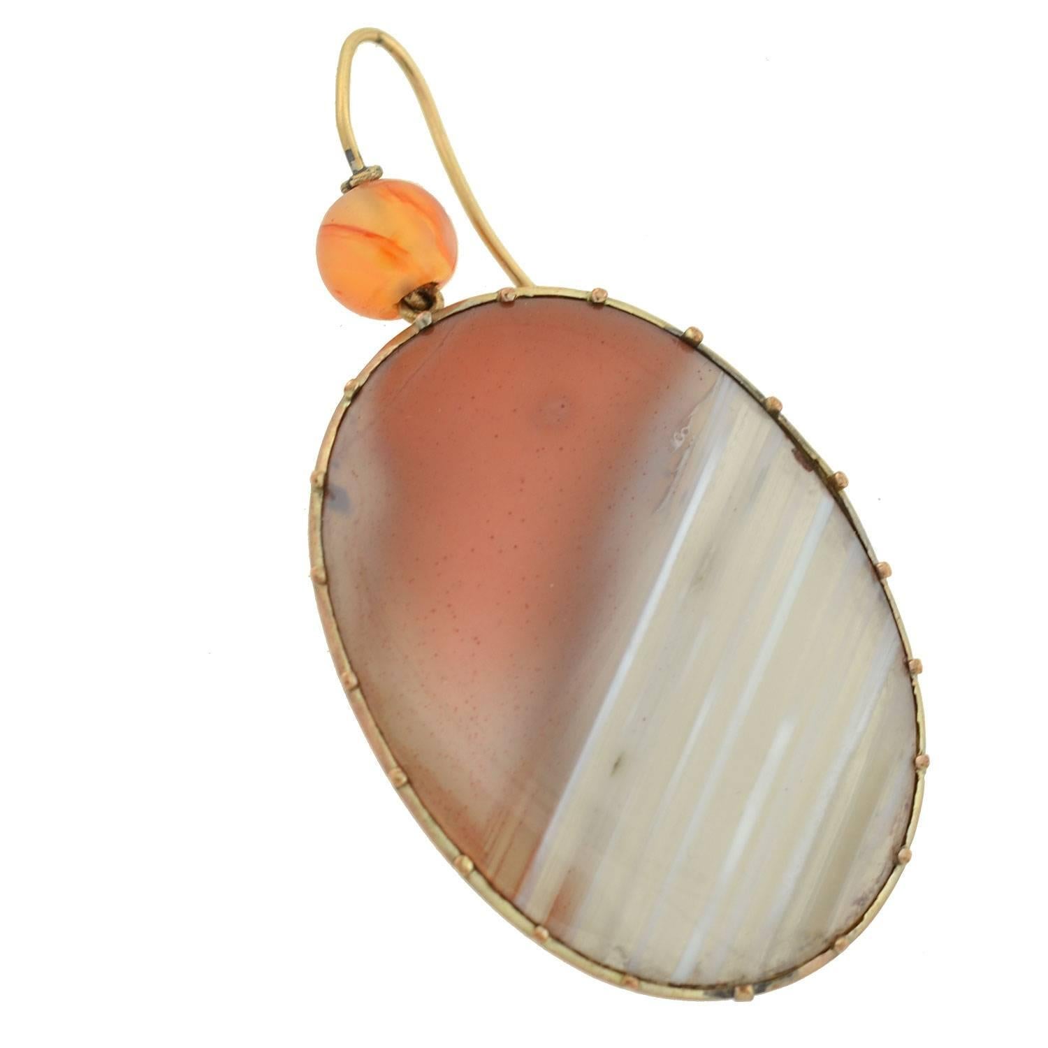 Wonderful and unusual carnelian agate earrings from the Victorian (ca1880) era! Each earring begins with a smooth ball of carnelian which has a 15kt yellow gold wire riveting through the center and attaches to a gold earring wire. Swinging from the