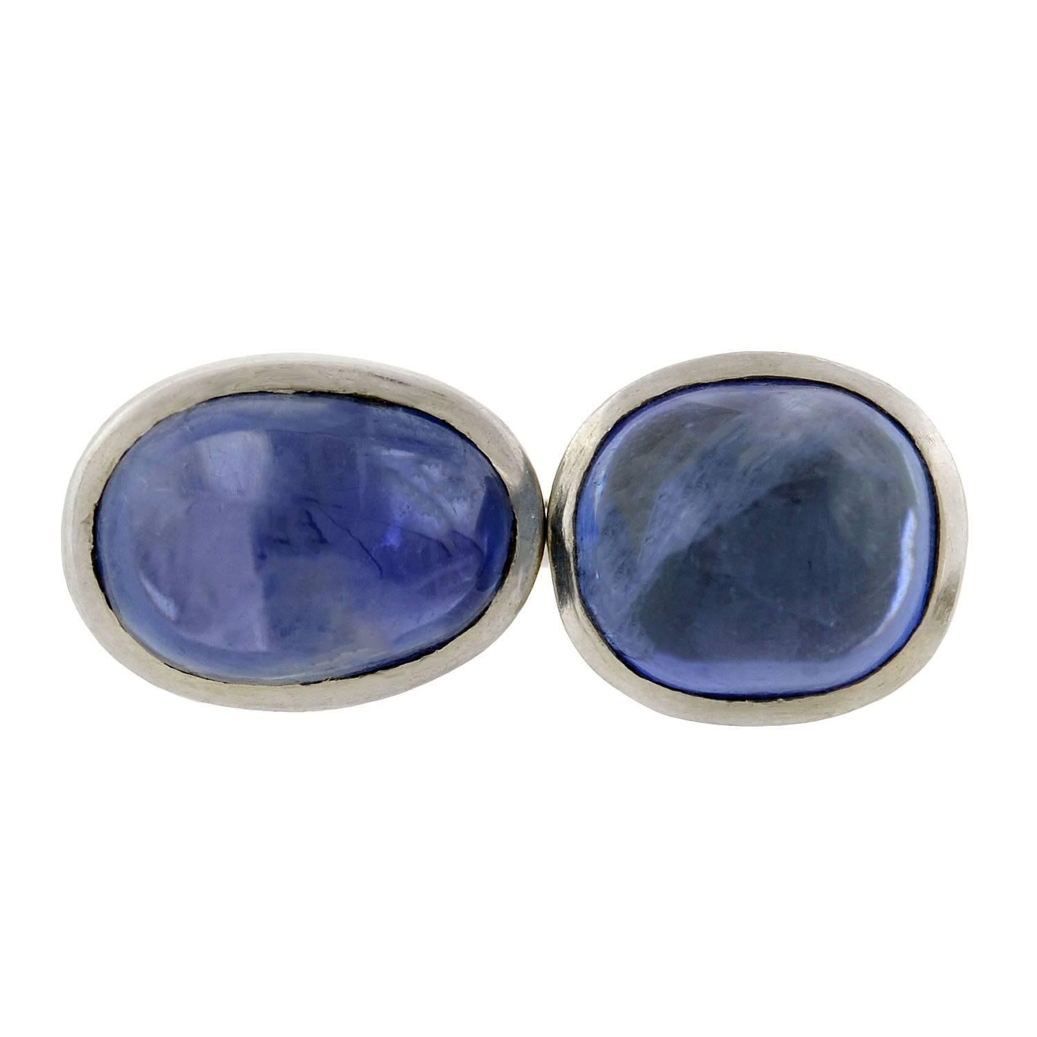 An incredible pair of natural sapphire cufflinks from the Art Deco (ca1920s) era! Crafted in smooth platinum, each of these double-sided cufflinks has a rounded face with a stunning natural sapphire stone set in the center. The rich sapphire