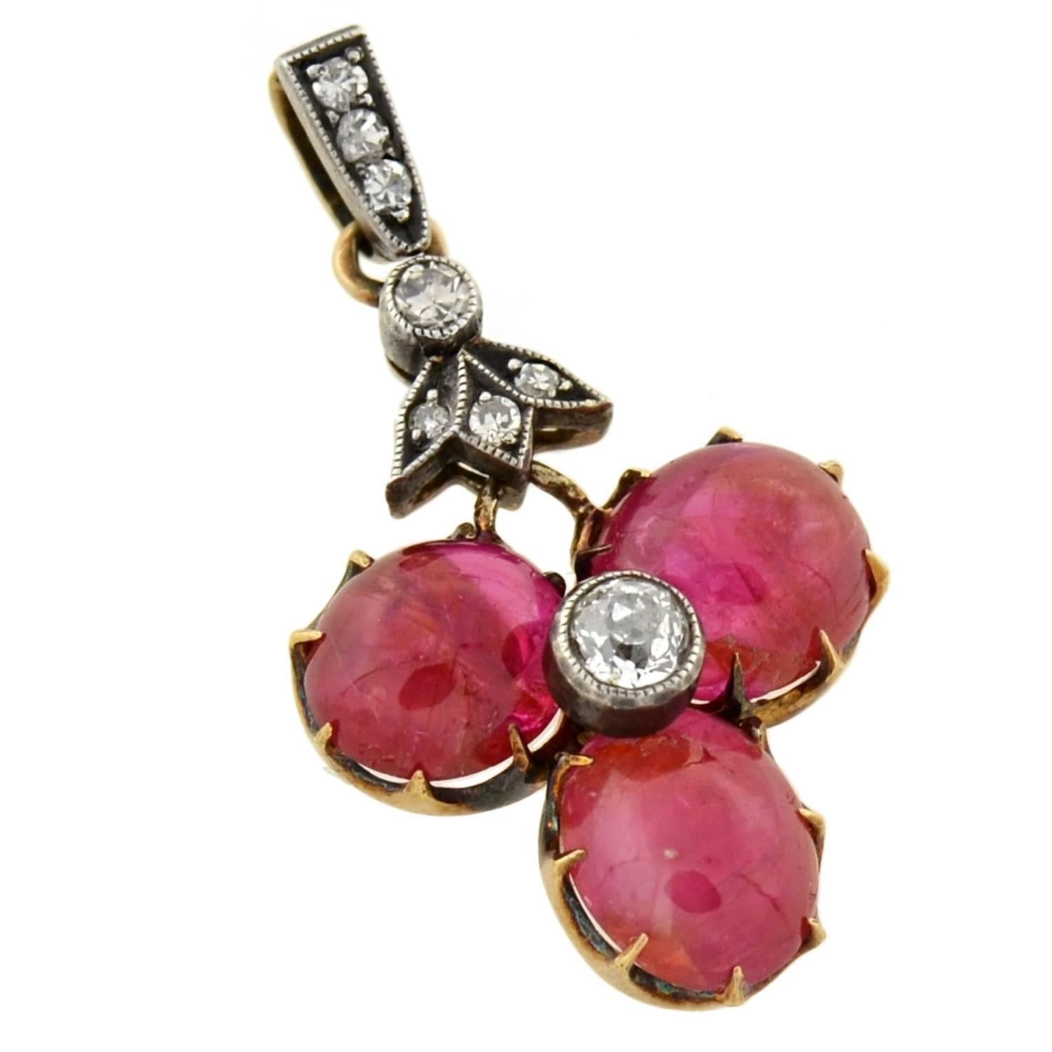 A beautiful and delicate ruby trefoil pendant from the Victorian (ca1880) era! This exquisite pendant features three luscious ruby cabochons that form the 