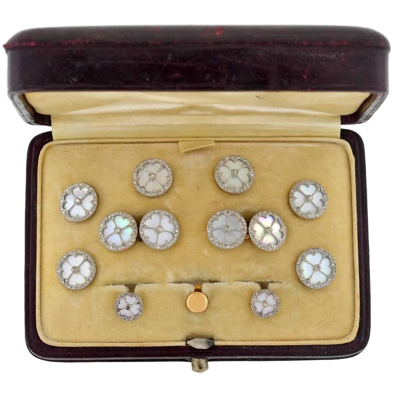 An exquisite cufflink set from the Edwardian (ca1910) era! This spectacular set is French in origin and is crafted in platinum-topped 18kt gold.  The set comes in the original box and includes a pair of double-sided cufflinks, 6 buttons with pins,