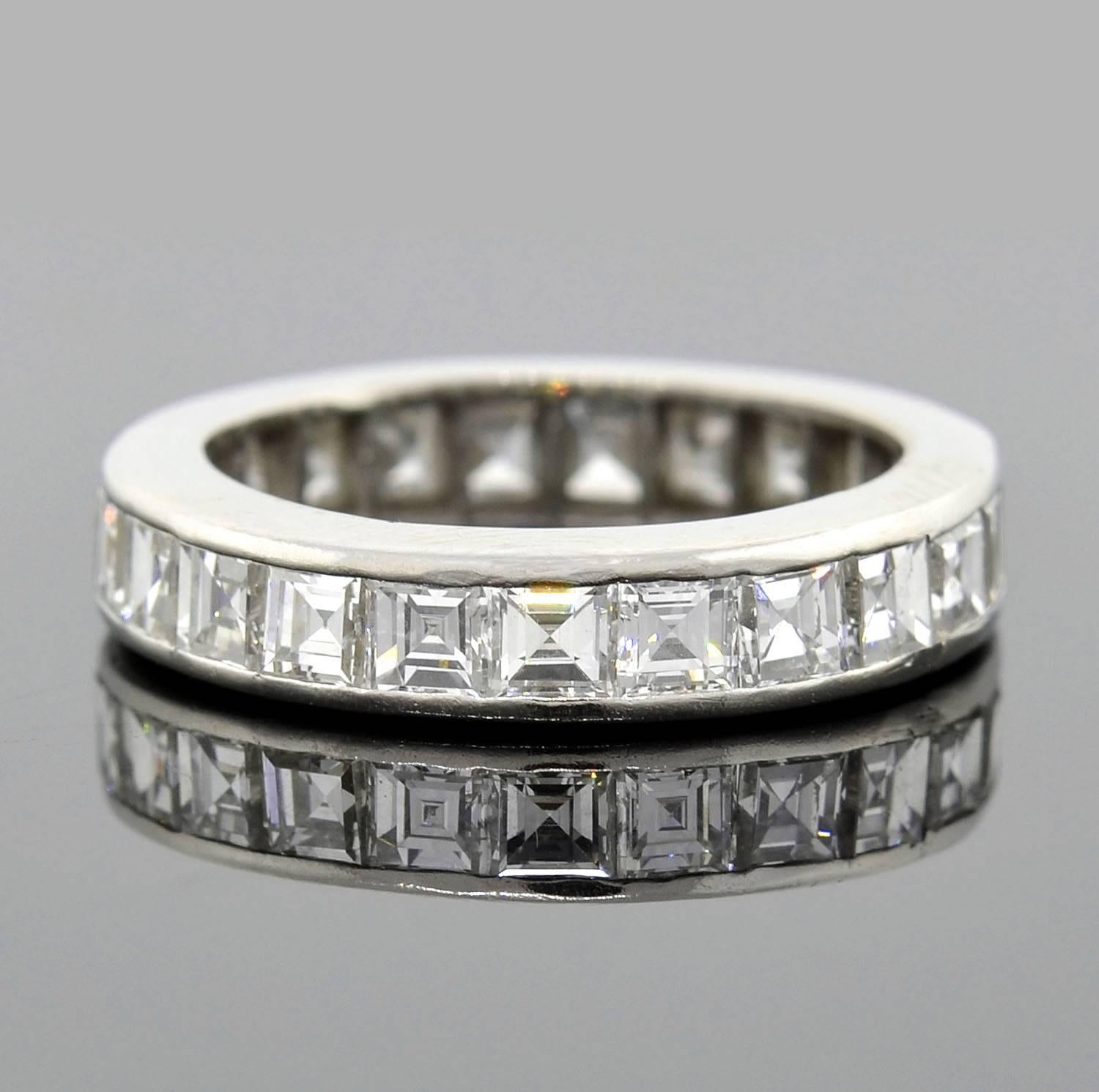 A stunning diamond eternity band from the Retro (ca1940) era! This gorgeous ring is made of platinum and holds a continuous row of sparkling square cut diamonds in a channel setting. The diamonds carry seamlessly around the entire surface of the